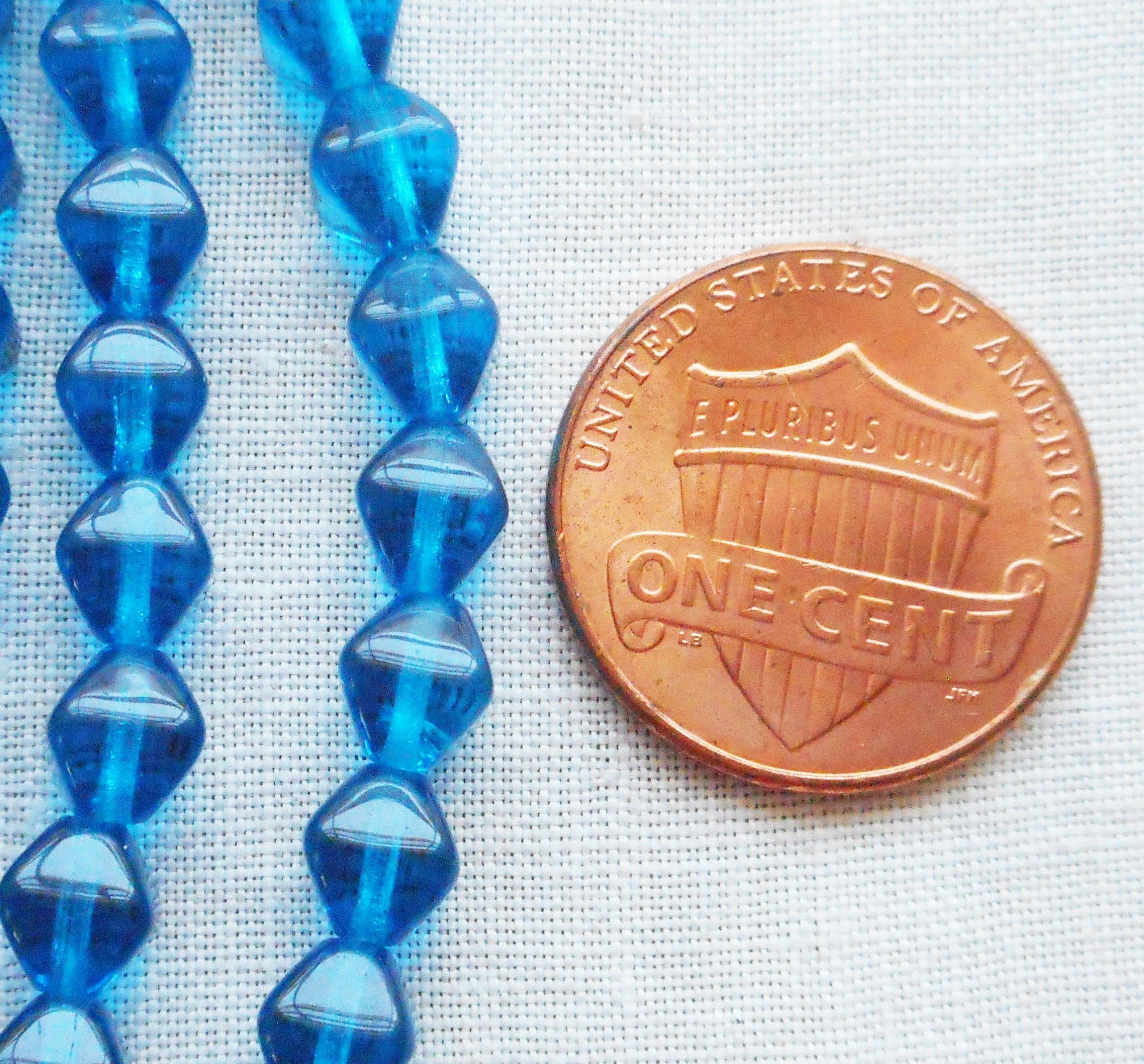 Fifty 6mm Capri Blue bicones, pressed glass Czech beads, C8550