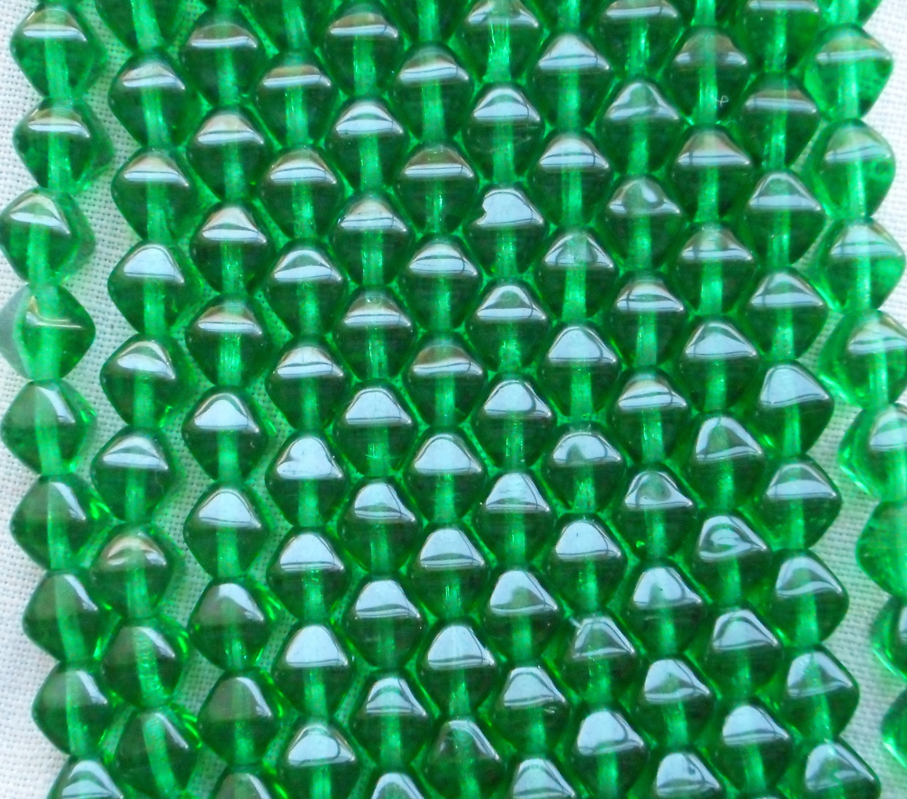 Fifty 6mm Emerald Green bicones, pressed glass Czech bicone beads C5501