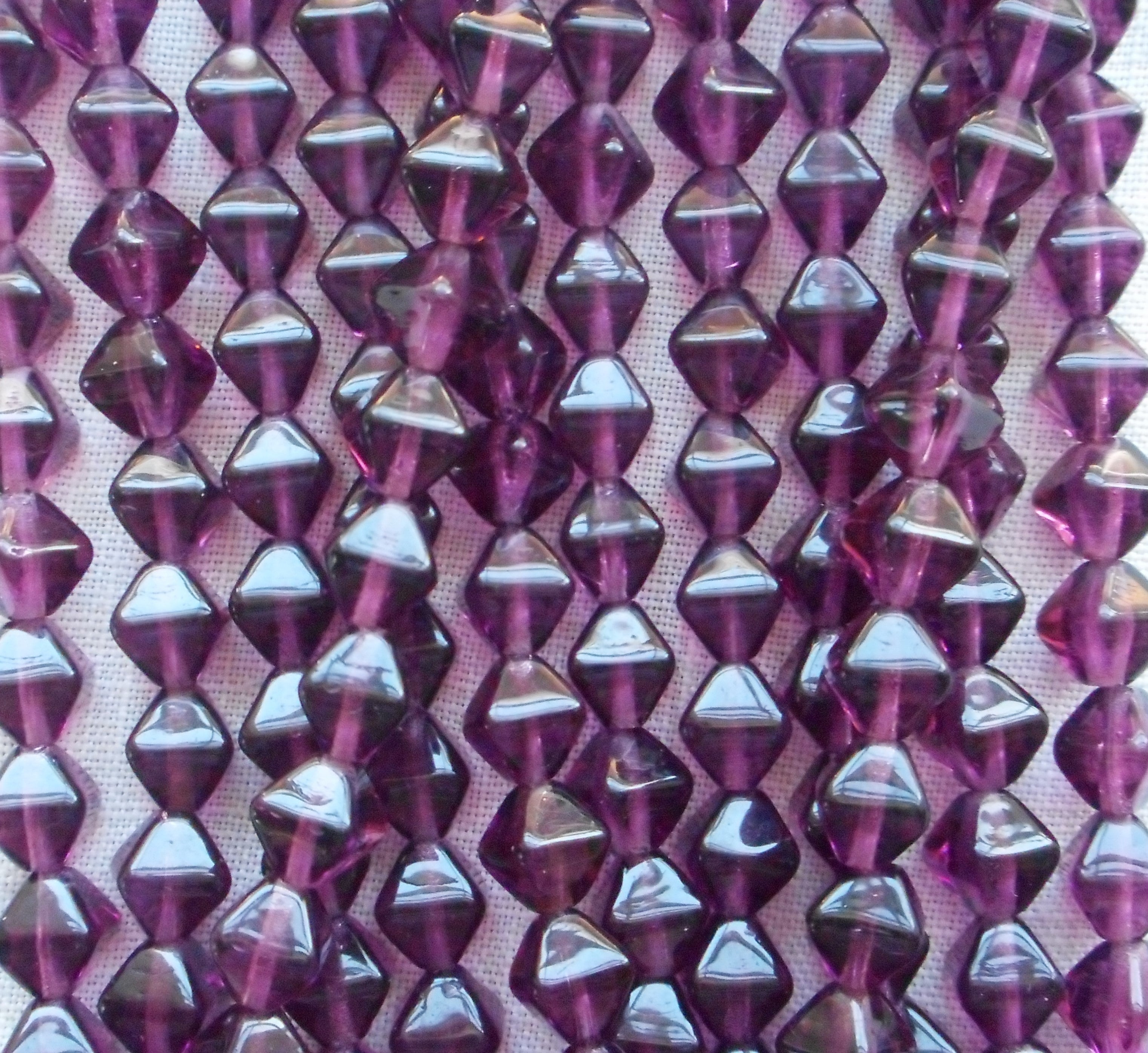 Fifty 6mm Amethyst bicones, Purple pressed glass Czech bicone beads C7501