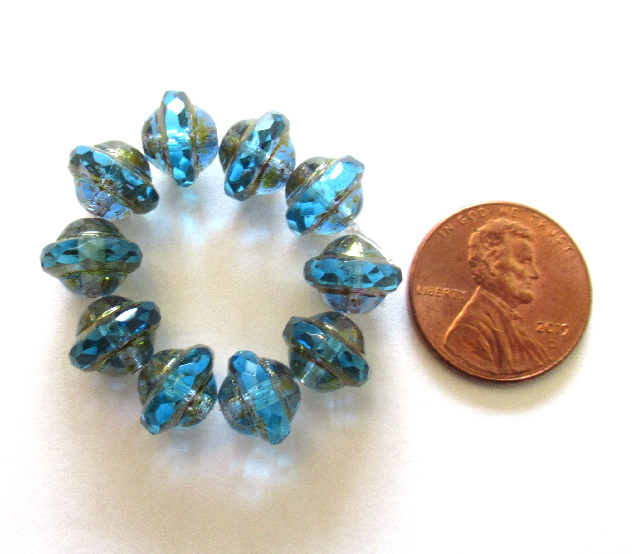 Ten Czech glass saturn or sauceer beads - 8mm x 10mm transparent aqua blue faceted beads with a bronze finish - C00141
