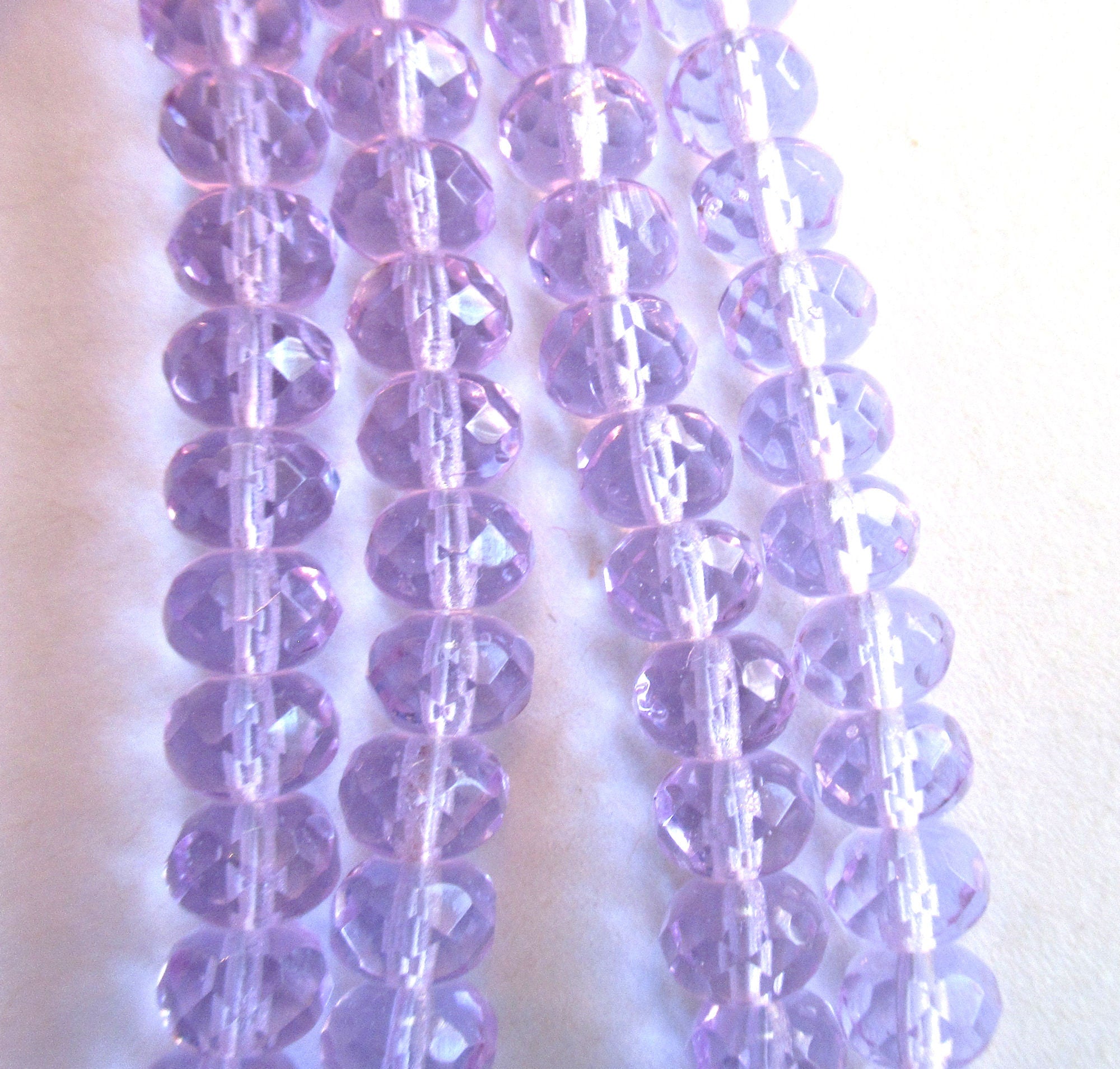Lot of 25 faceted puffy rondelle or donut beads - 5 x 7mm transparent alexandrite or lavender beads - C0055