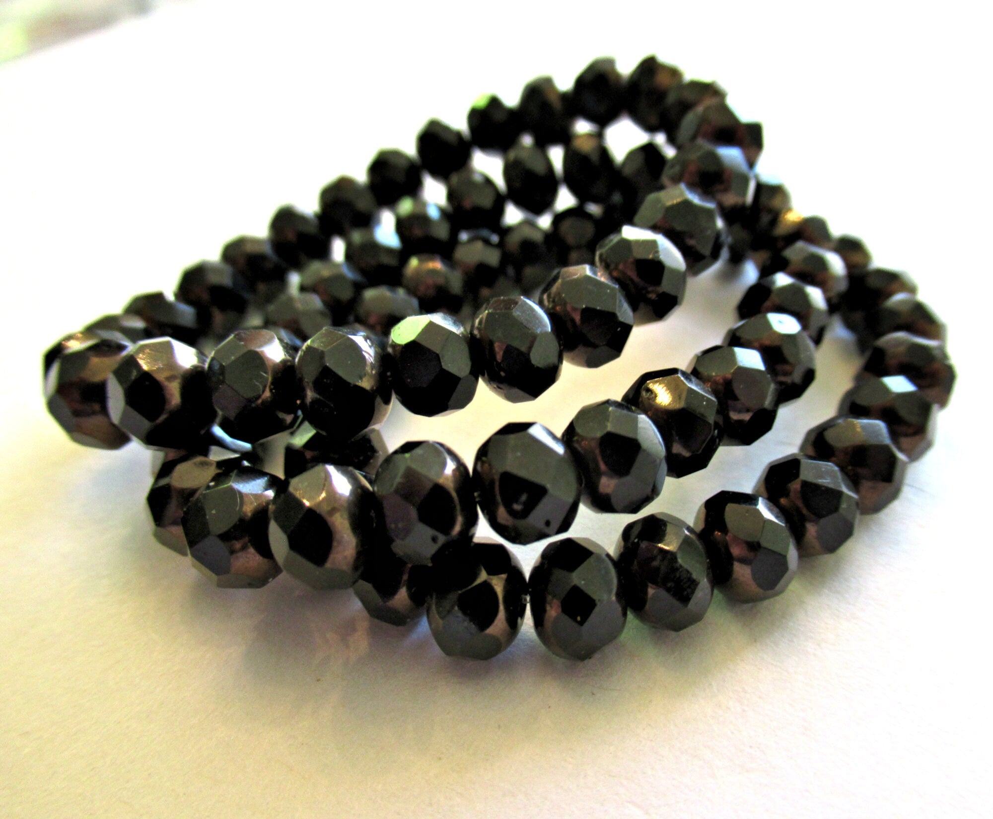 25 Czech glass puffy rondelle or donut beads - 5 x 7mm jet black beads w/ bronze finish on the ends - fire polished faceted rondelles 00612
