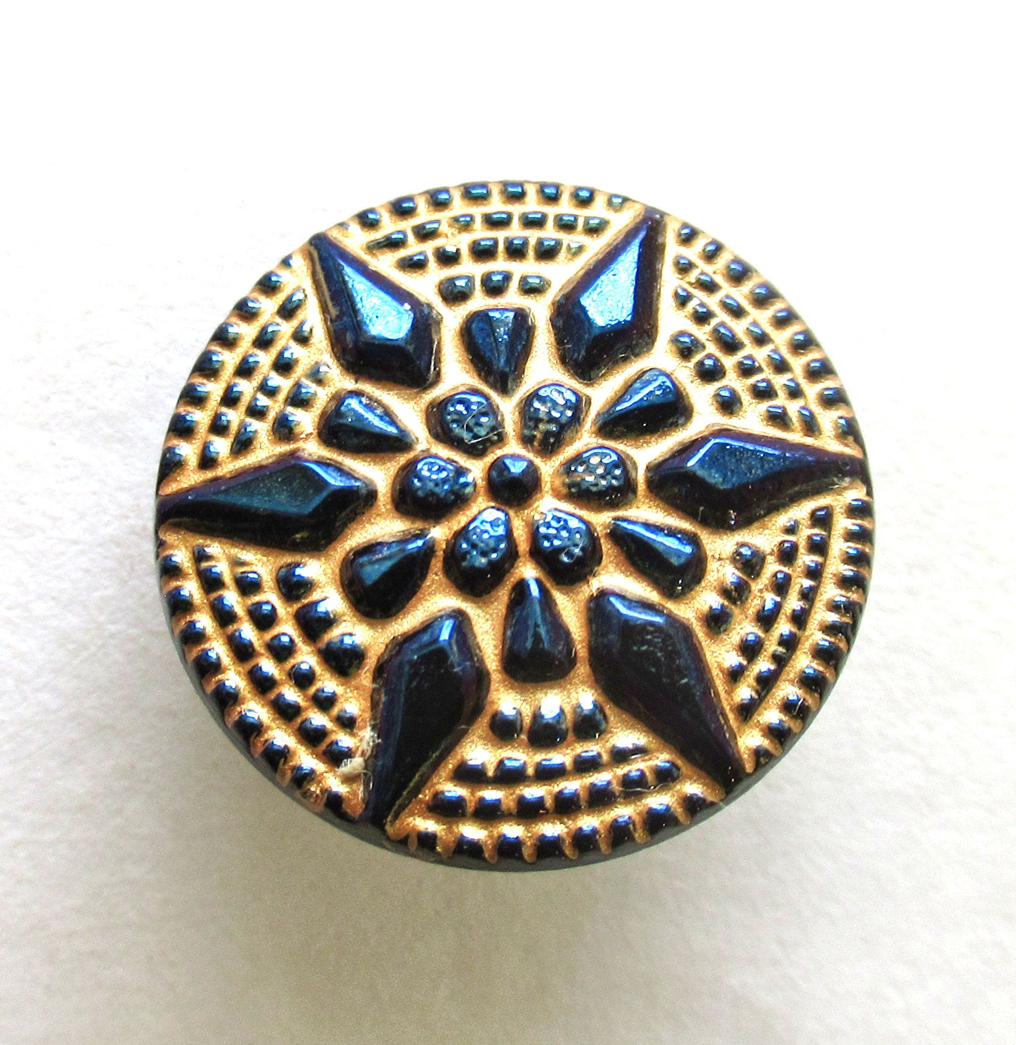 One 18mm Czech art glass button - dark blue raised star with a gold wash - decorative shank button 00312