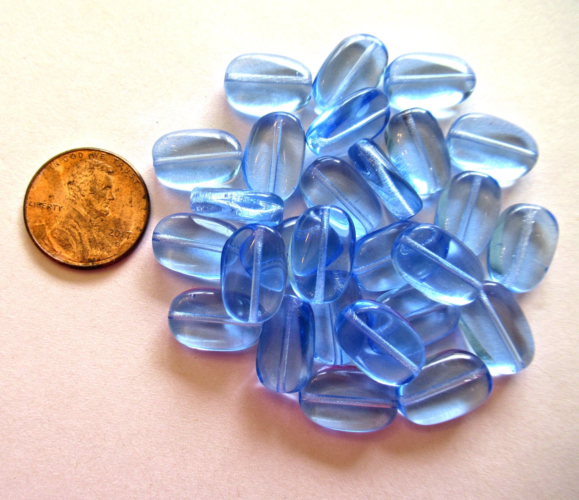 Lot of 15 transparent light sapphire blue slightly twisted oval Czech Glass beads - 14mm x 8mm pressed glass beads C0032