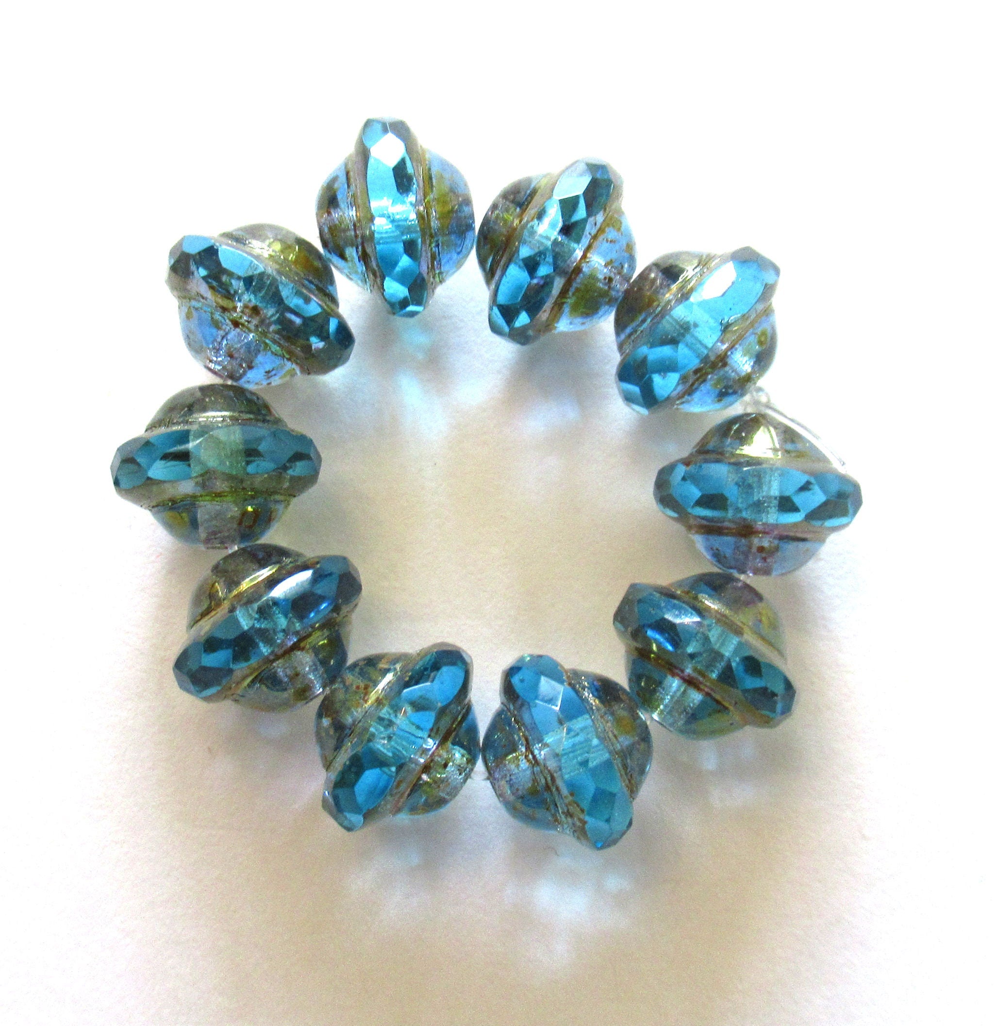 Ten Czech glass saturn or sauceer beads - 8mm x 10mm transparent aqua blue faceted beads with a bronze finish - C00141