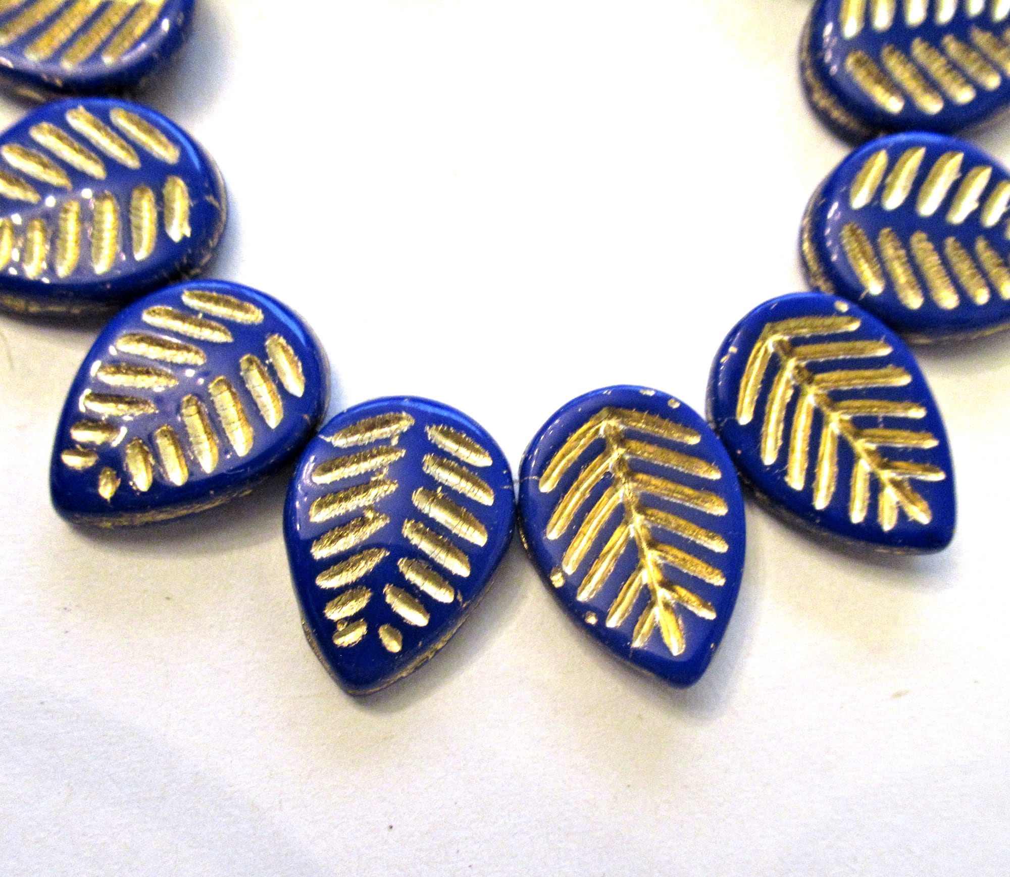 Ten large Czech glass leaf beads - side drilled - opaque royal blue beads with a gold wash - 12 x 16mm carved beads C00041