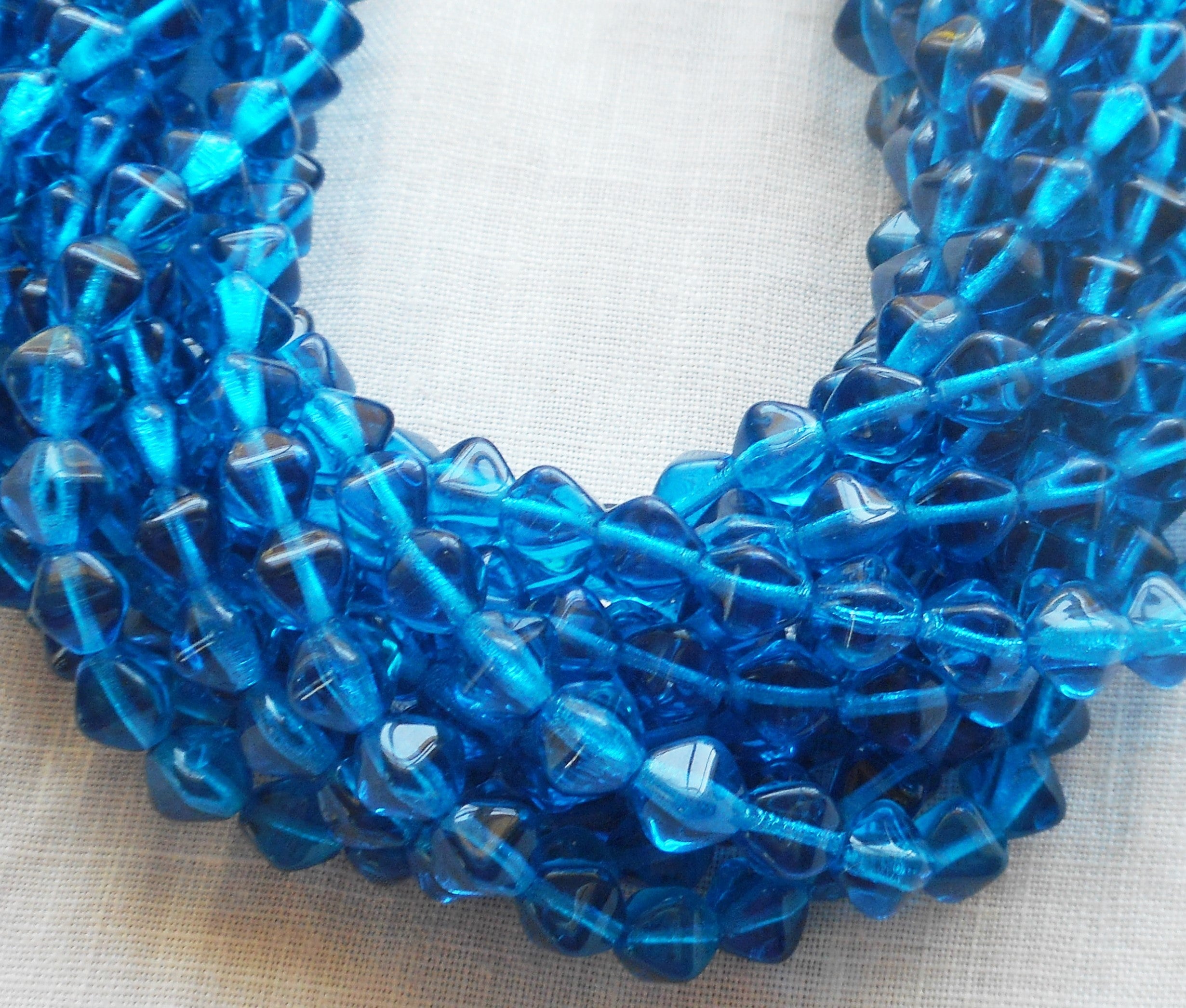 Fifty 6mm Capri Blue bicones, pressed glass Czech beads, C8550