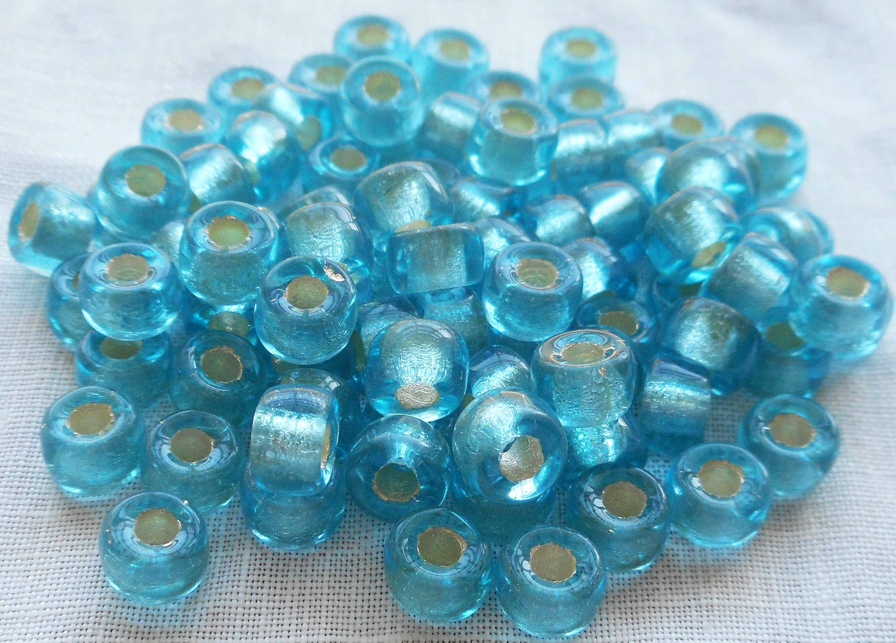 Fifty 6mm aqua blue silver lined Czech glass pony, roller beads, large hole crow beads C5401