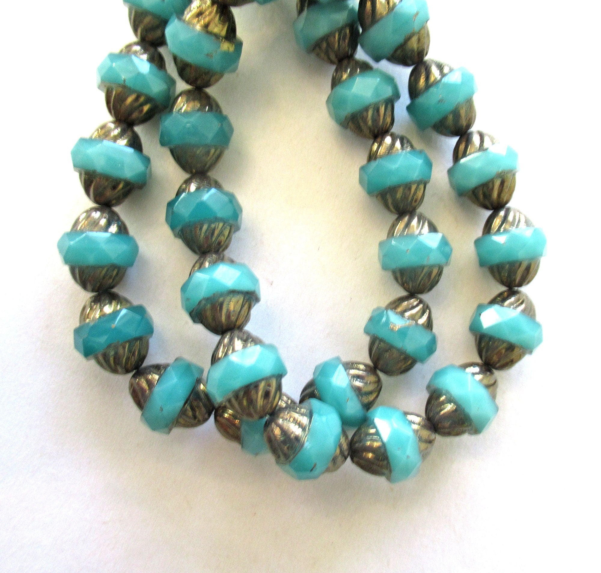Ten Czech glass turbine beads - 11 x 10mm light translucent milky blue green faceted saucer beads with a bronze finish on the ends - C00652