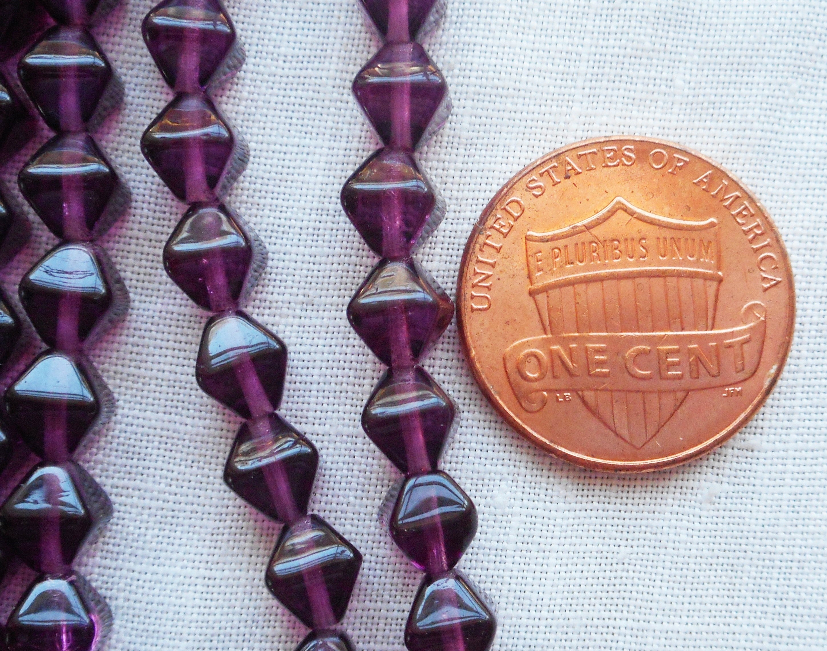 Fifty 6mm Amethyst bicones, Purple pressed glass Czech bicone beads C7501