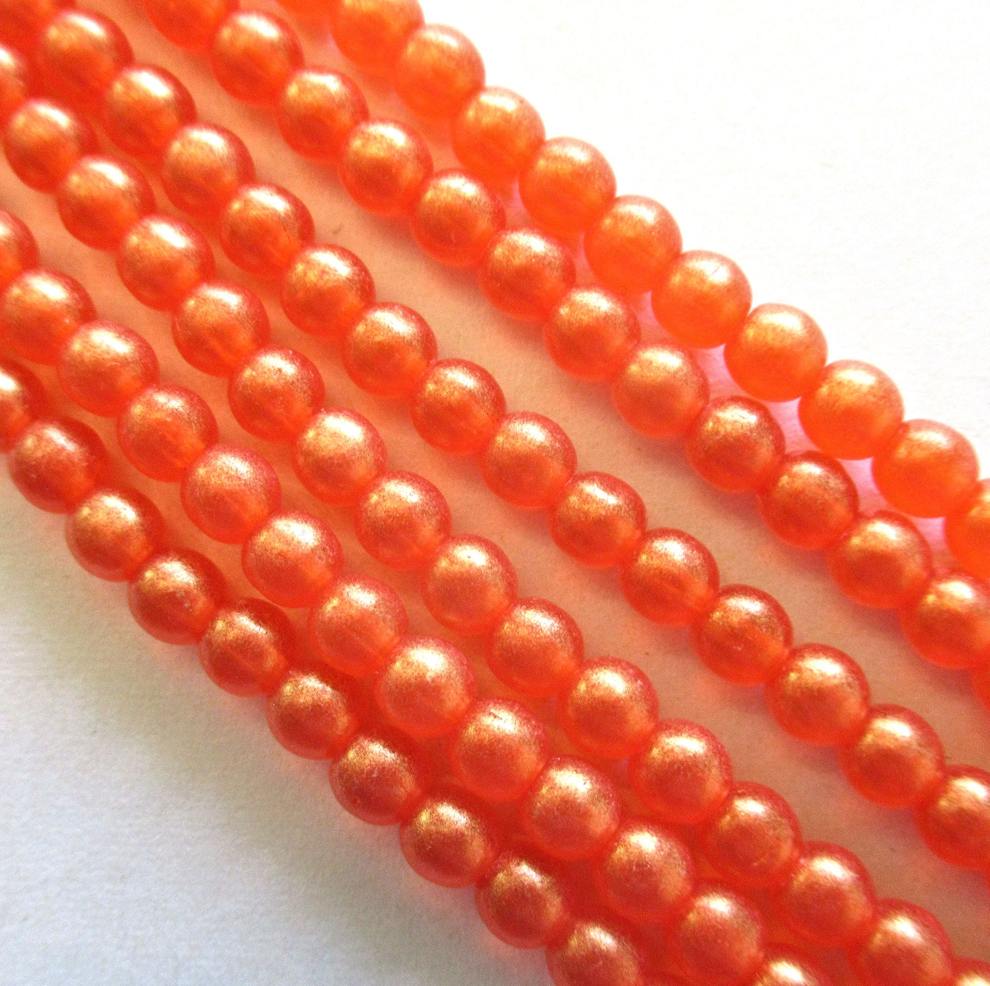 100 4mm Czech glass druks - Sueded Gold Hyacinth - bright orange tangerine, smooth round druk beads with a gold finish C0055
