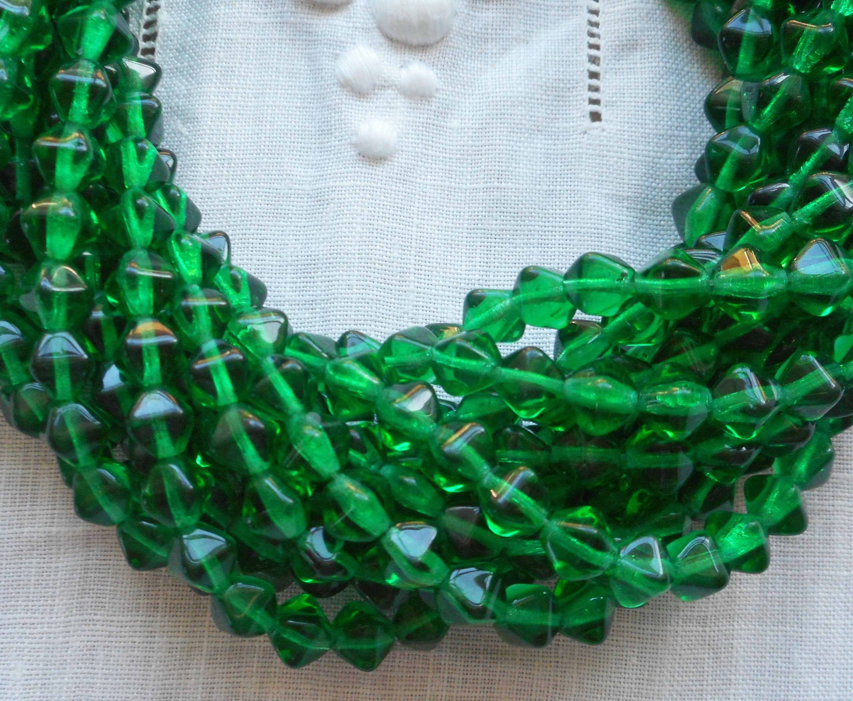 Fifty 6mm Emerald Green bicones, pressed glass Czech bicone beads C5501