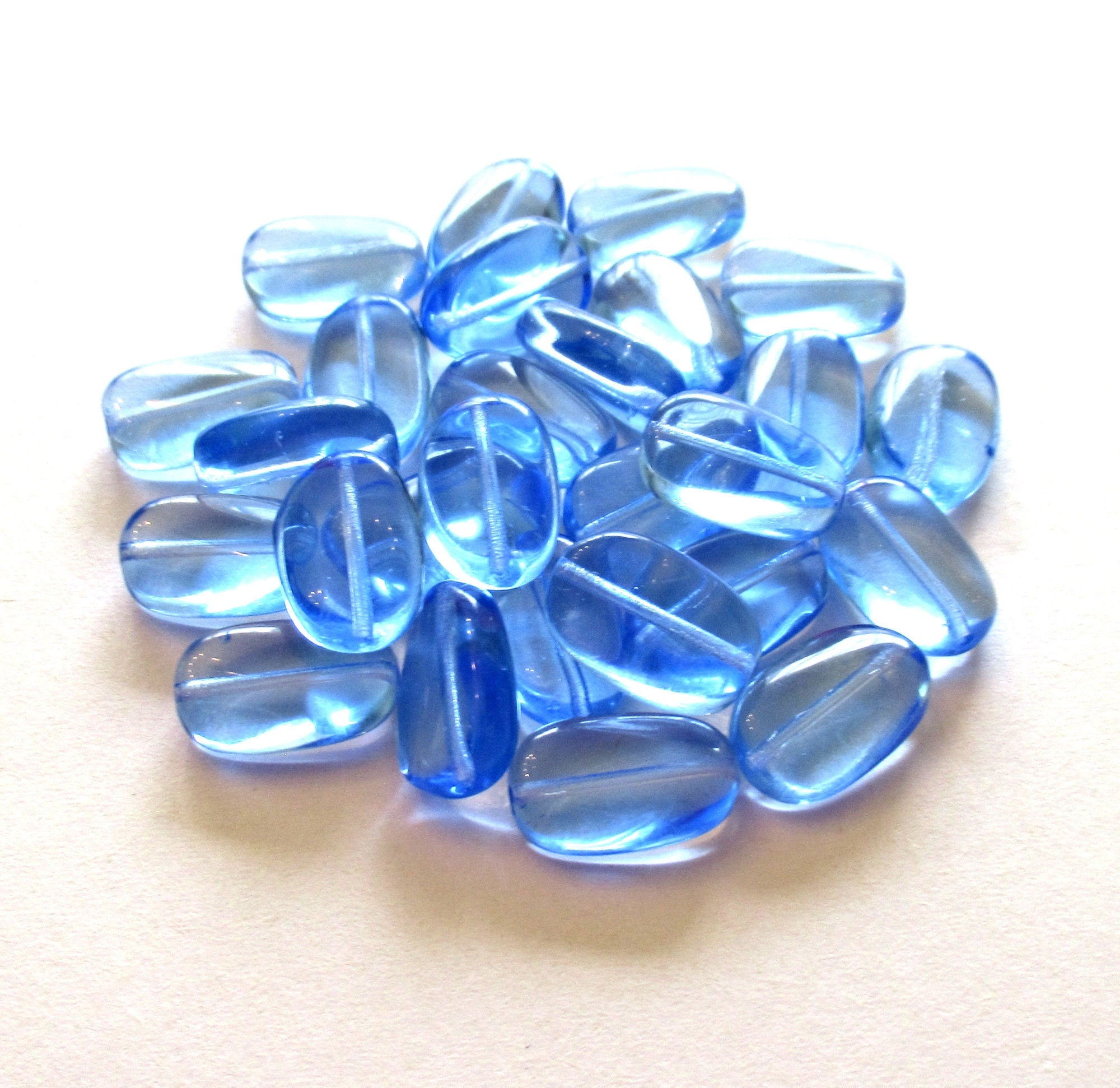 Lot of 15 transparent light sapphire blue slightly twisted oval Czech Glass beads - 14mm x 8mm pressed glass beads C0032