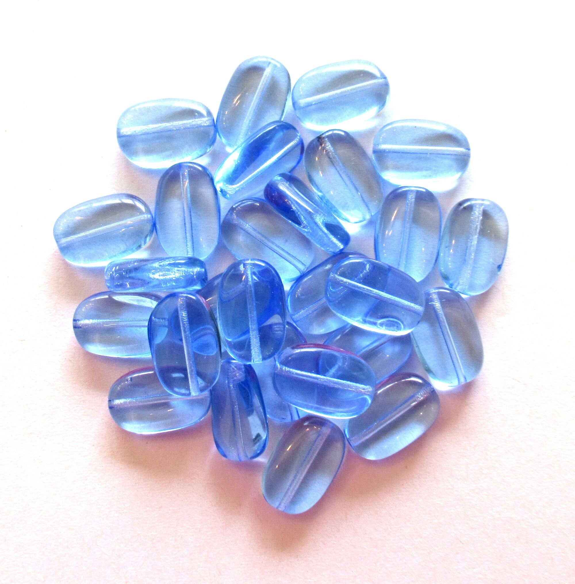 Lot of 15 transparent light sapphire blue slightly twisted oval Czech Glass beads - 14mm x 8mm pressed glass beads C0032