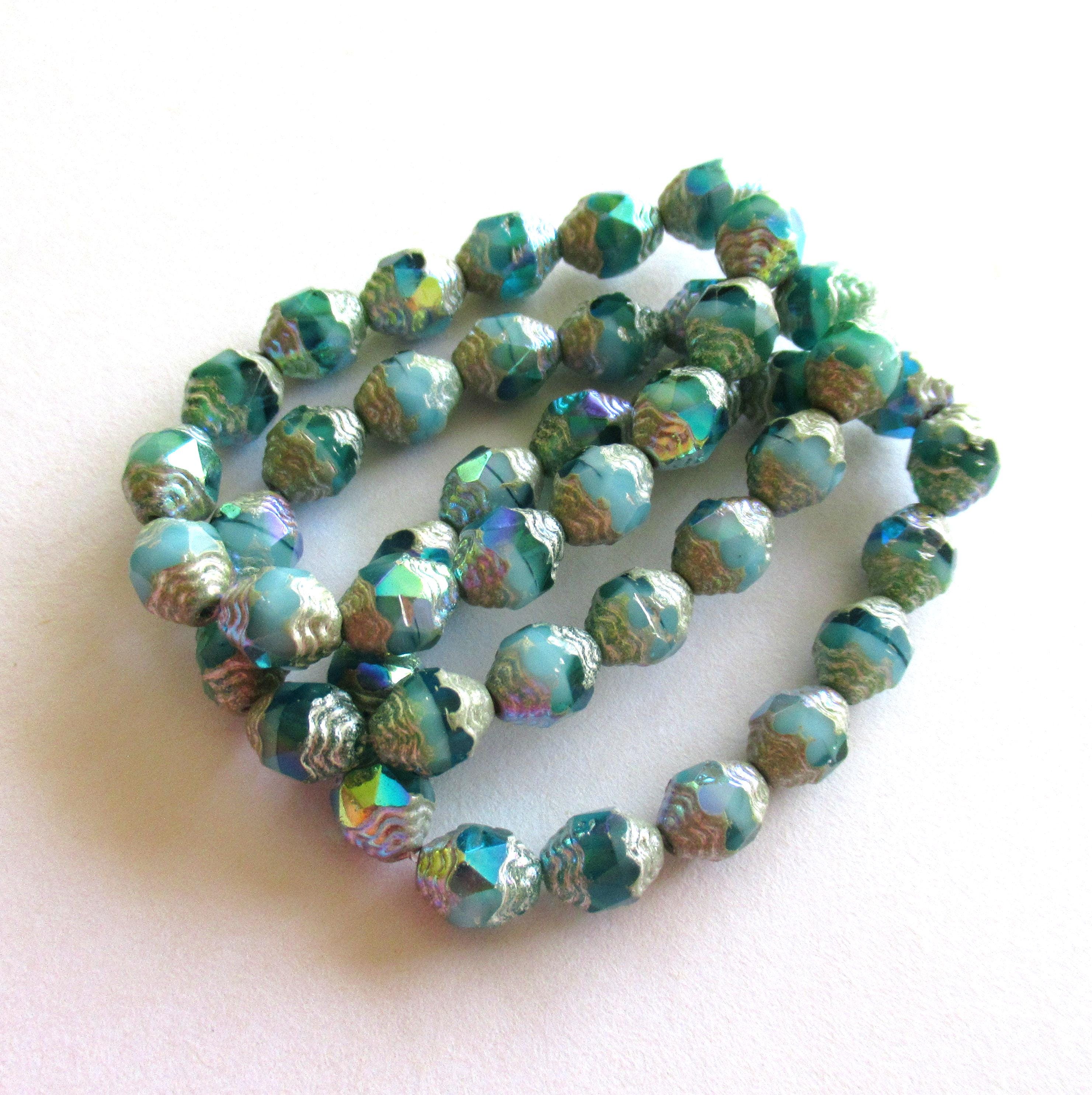 15 Czech glass mini antique style faceted carved oval cathedral beads - 8 x 6mm - opaque & transparent blue green ab w/ silver accents - C000572