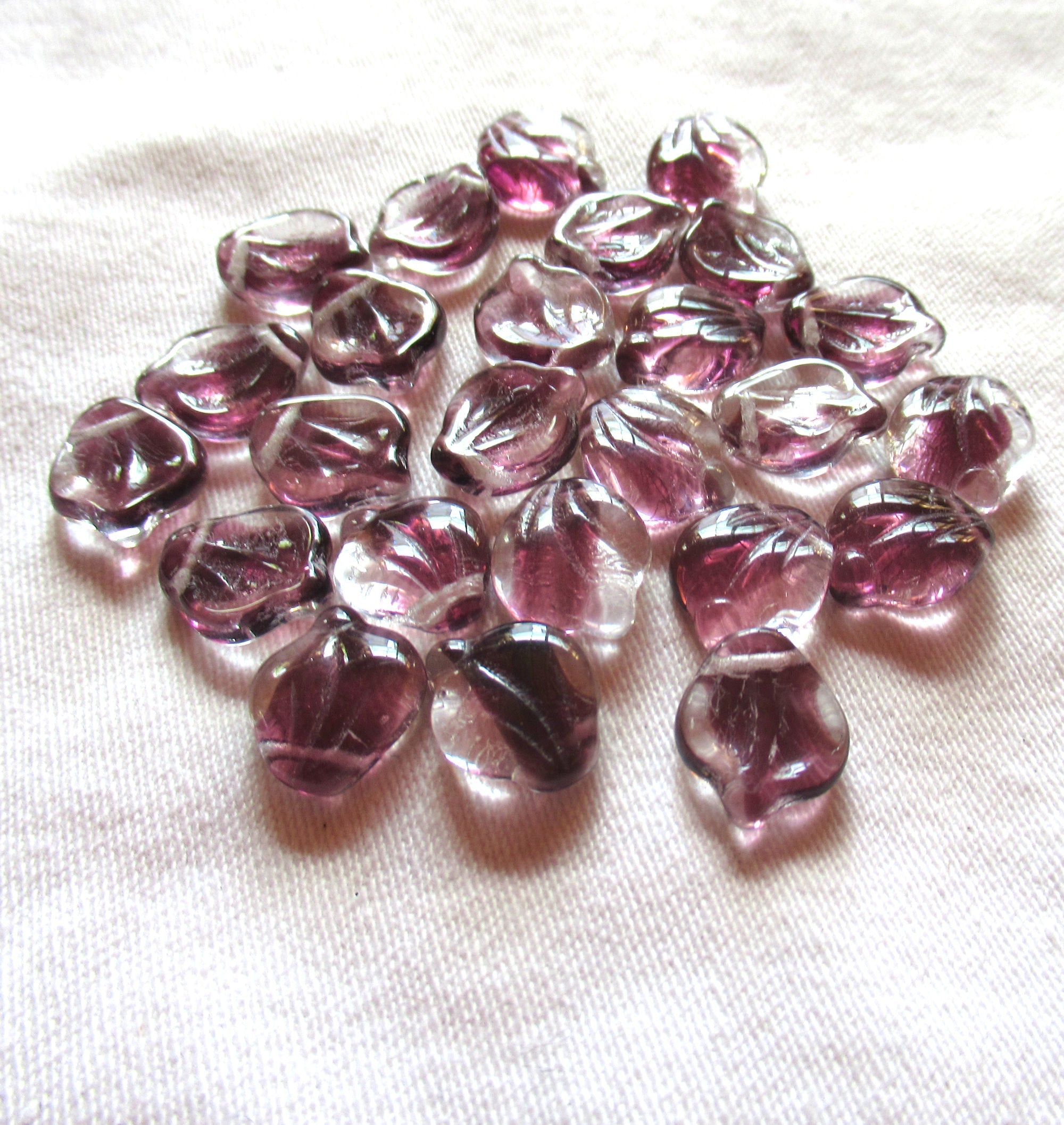 Ten 12 x 15m large Czech glass leaf beads, - crystal clear with streaks of purple or amethyst side drilled beads