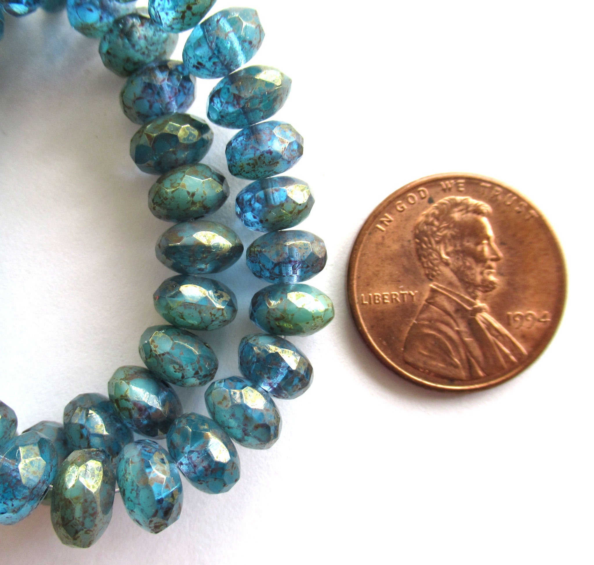 Lot of 25 faceted puffy rondelle or donut Czech glass beads - 5 x 7mm transparent sea blue with a splotchy purple luster finish - C00201