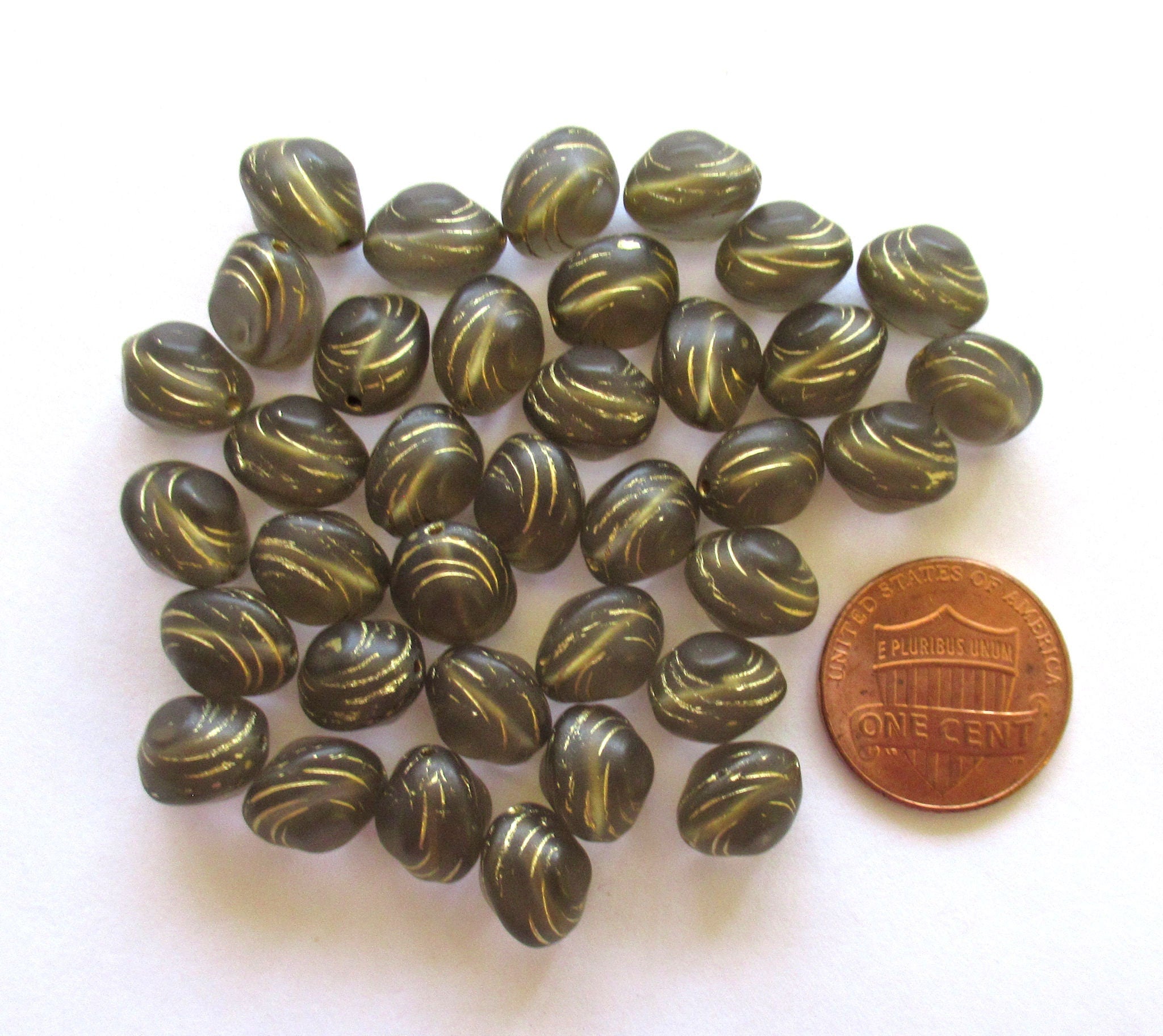 Lot of fifteen oval 10 x 9mm Czech glass snail beads - translucent gray and gold carved glass snail beads C12101