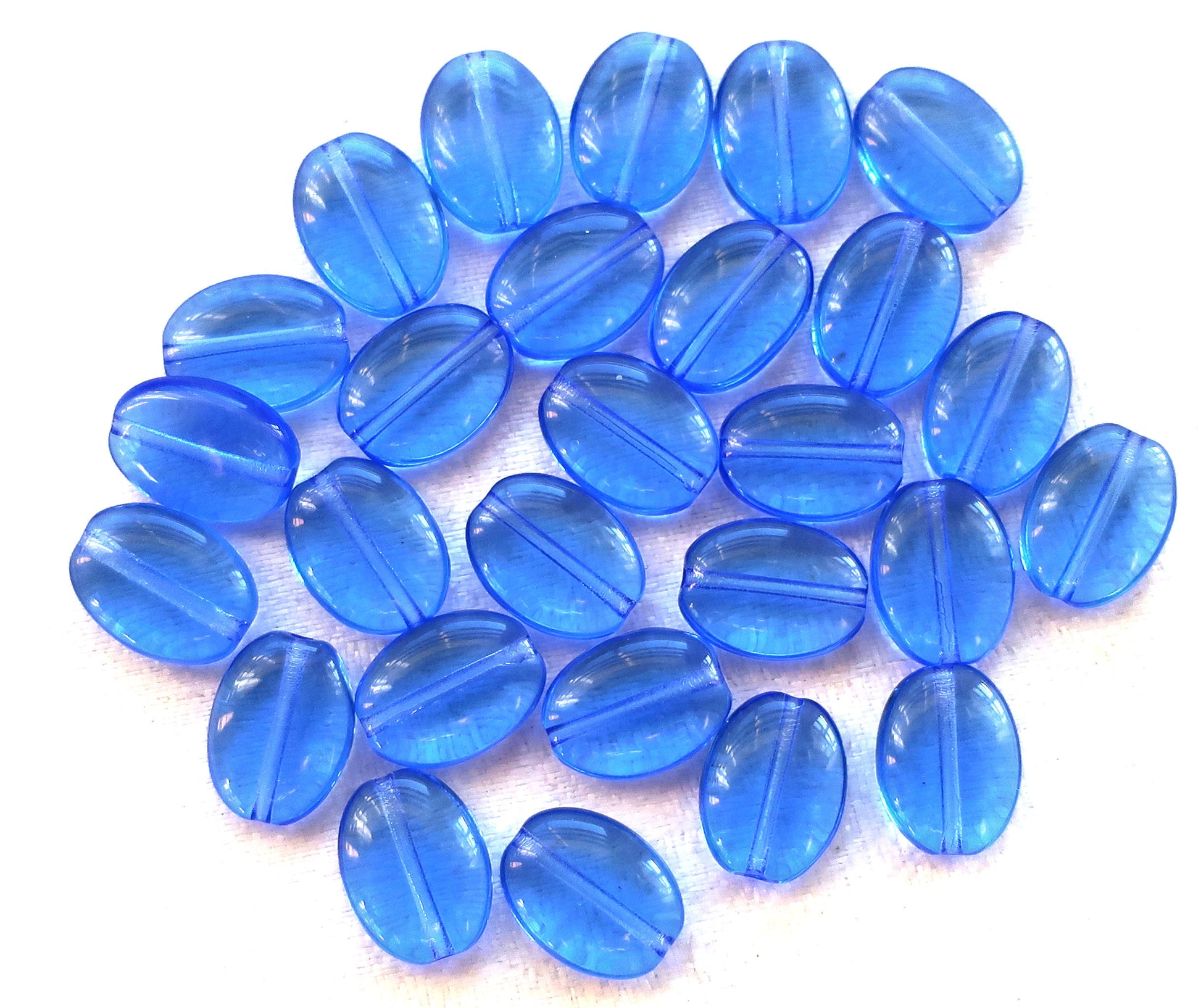 Lot of 25 transparent sapphire blue flat oval Czech Glass beads, 12mm x 9mm pressed glass beads C7425 - Glorious Glass Beads