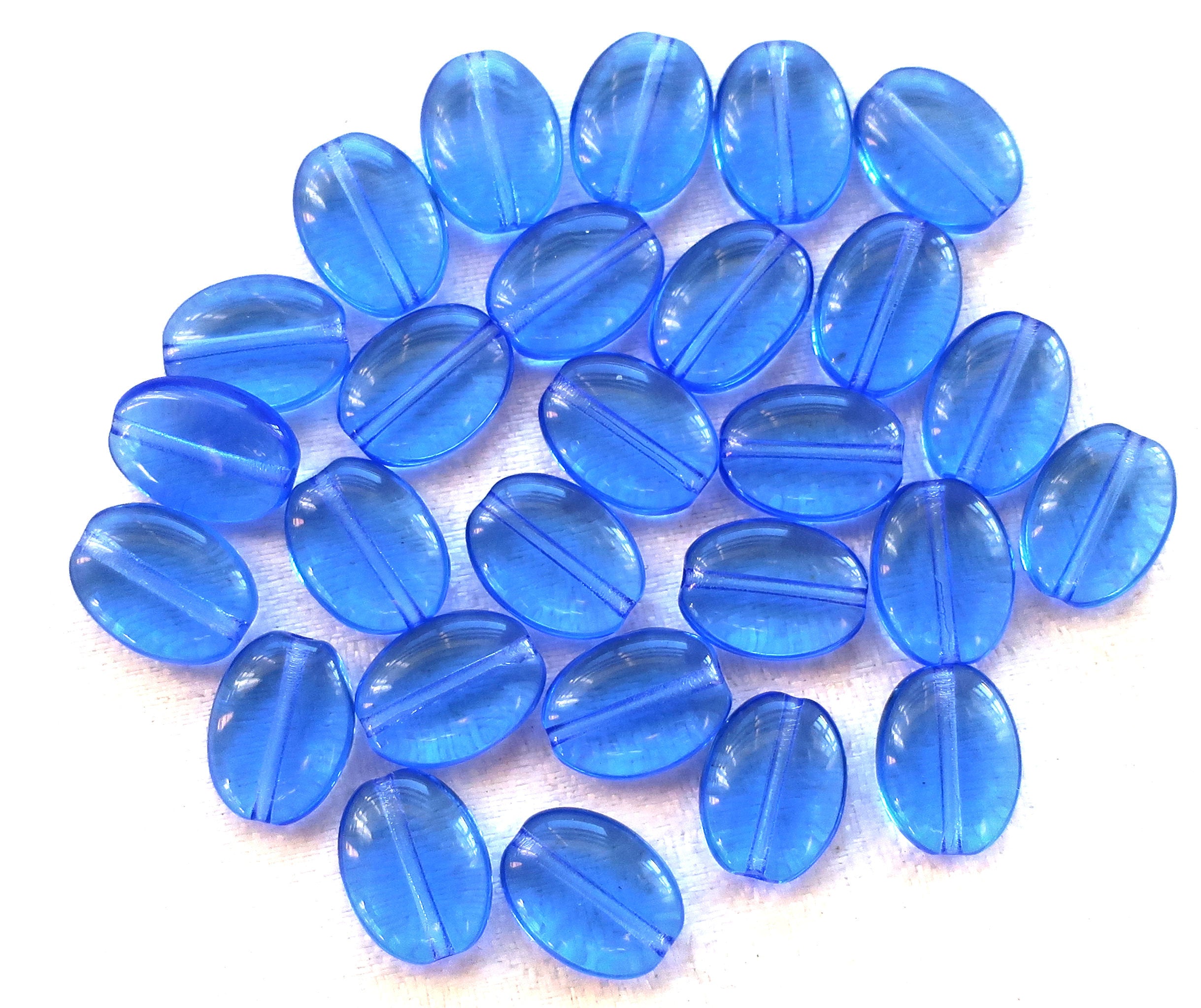 Lot of 25 transparent sapphire blue flat oval Czech Glass beads, 12mm x 9mm pressed glass beads C7425 - Glorious Glass Beads