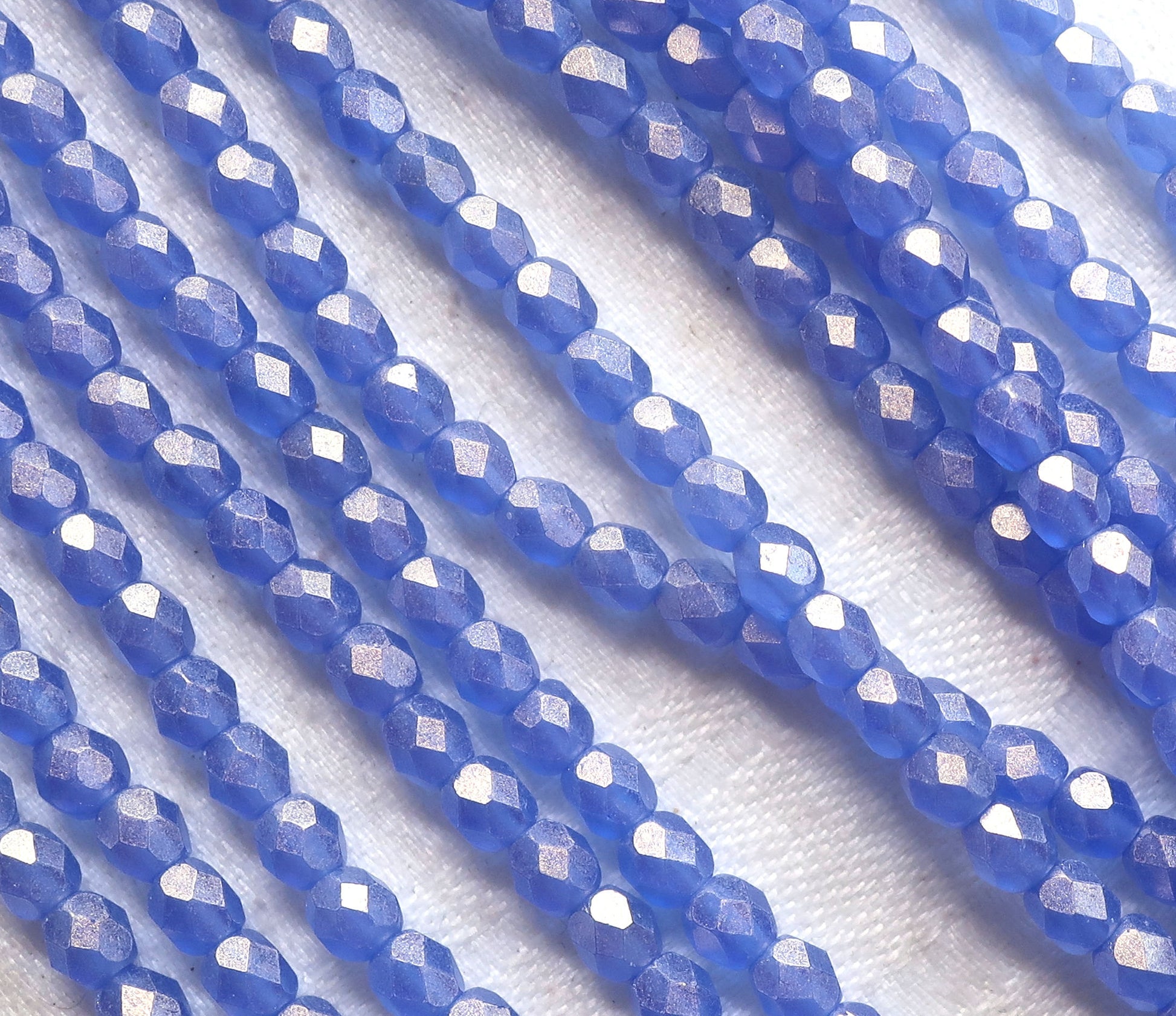 Lot of 50 4mm Czech glass beads, Sueded Gold Sapphire Blue firepolished, faceted beads. with a golden finish C9601 - Glorious Glass Beads