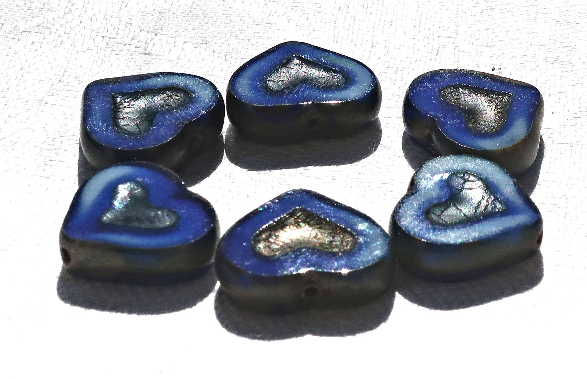 Six Czech glass heart beads; 14 x 12mm table cut, carved, opaque marbled royal blue & white glass hearts with a silver picasso finish C6906 - Glorious Glass Beads