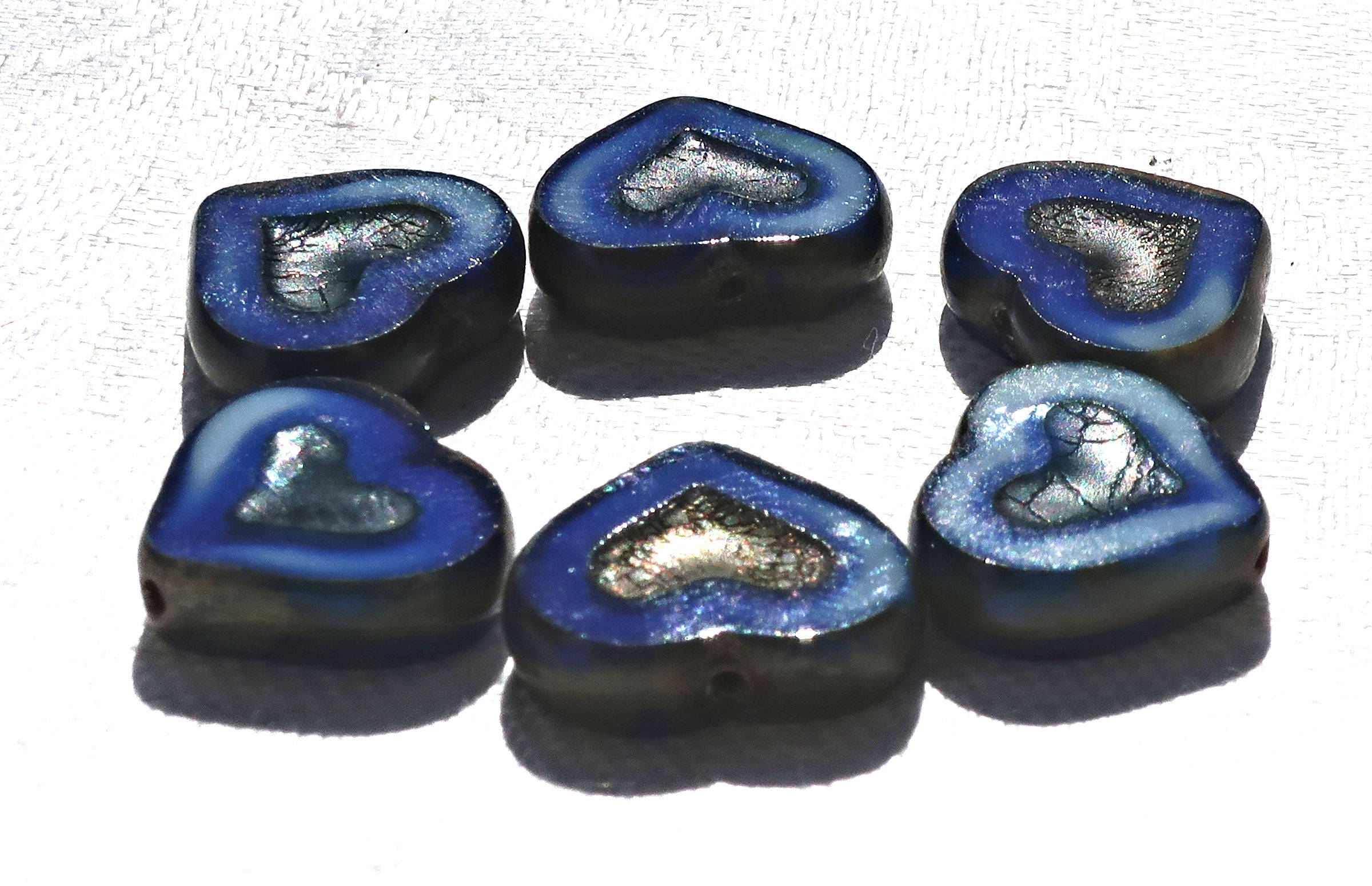 Six Czech glass heart beads; 14 x 12mm table cut, carved, opaque marbled royal blue & white glass hearts with a silver picasso finish C6906 - Glorious Glass Beads