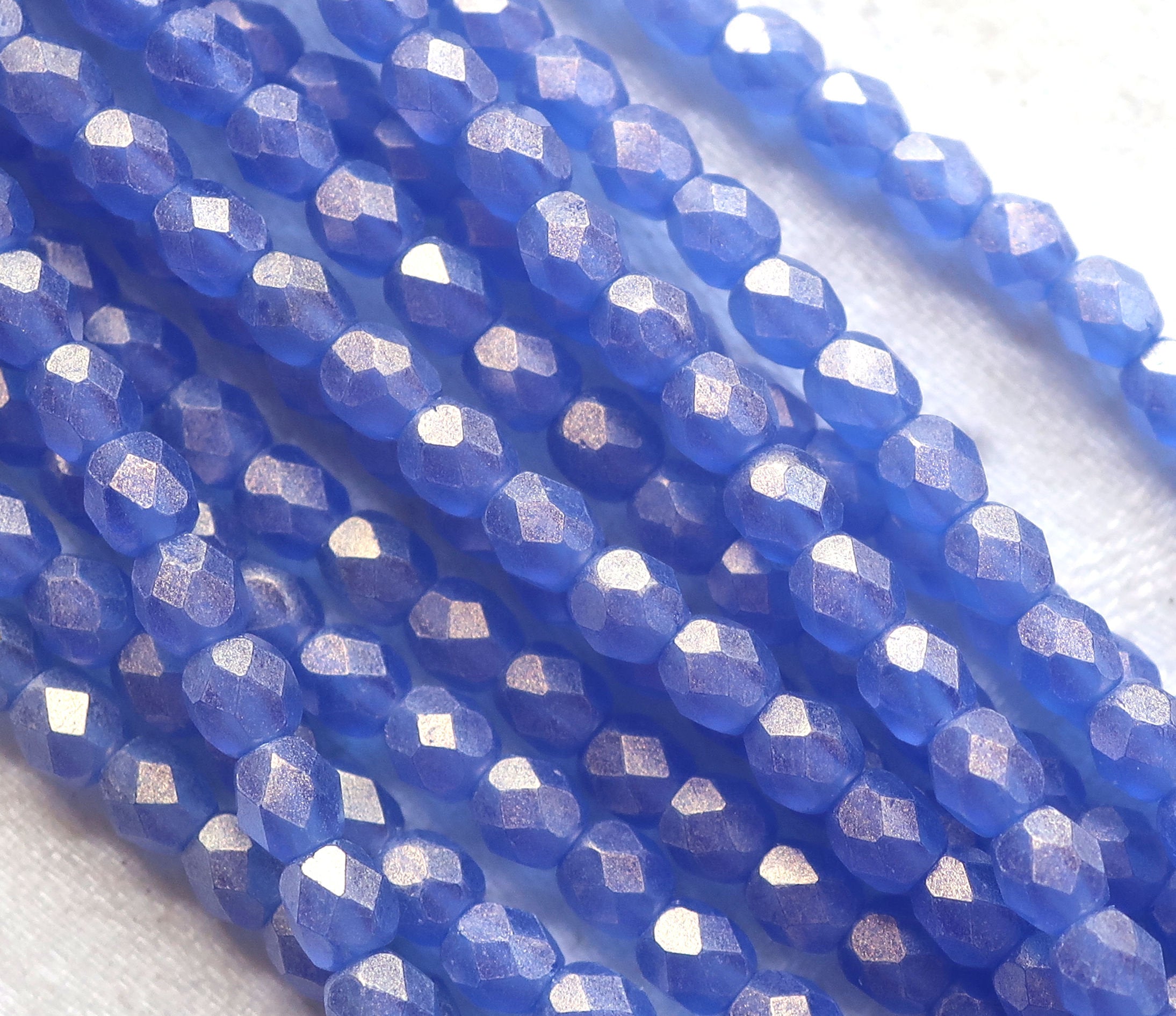 Lot of 50 4mm Czech glass beads, Sueded Gold Sapphire Blue firepolished, faceted beads. with a golden finish C9601 - Glorious Glass Beads