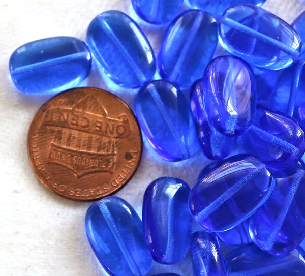 Lot of 25 transparent Sapphire Blue slightly twisted oval Czech Glass beads, 14mm x 8mm pressed glass beads C7325 - Glorious Glass Beads