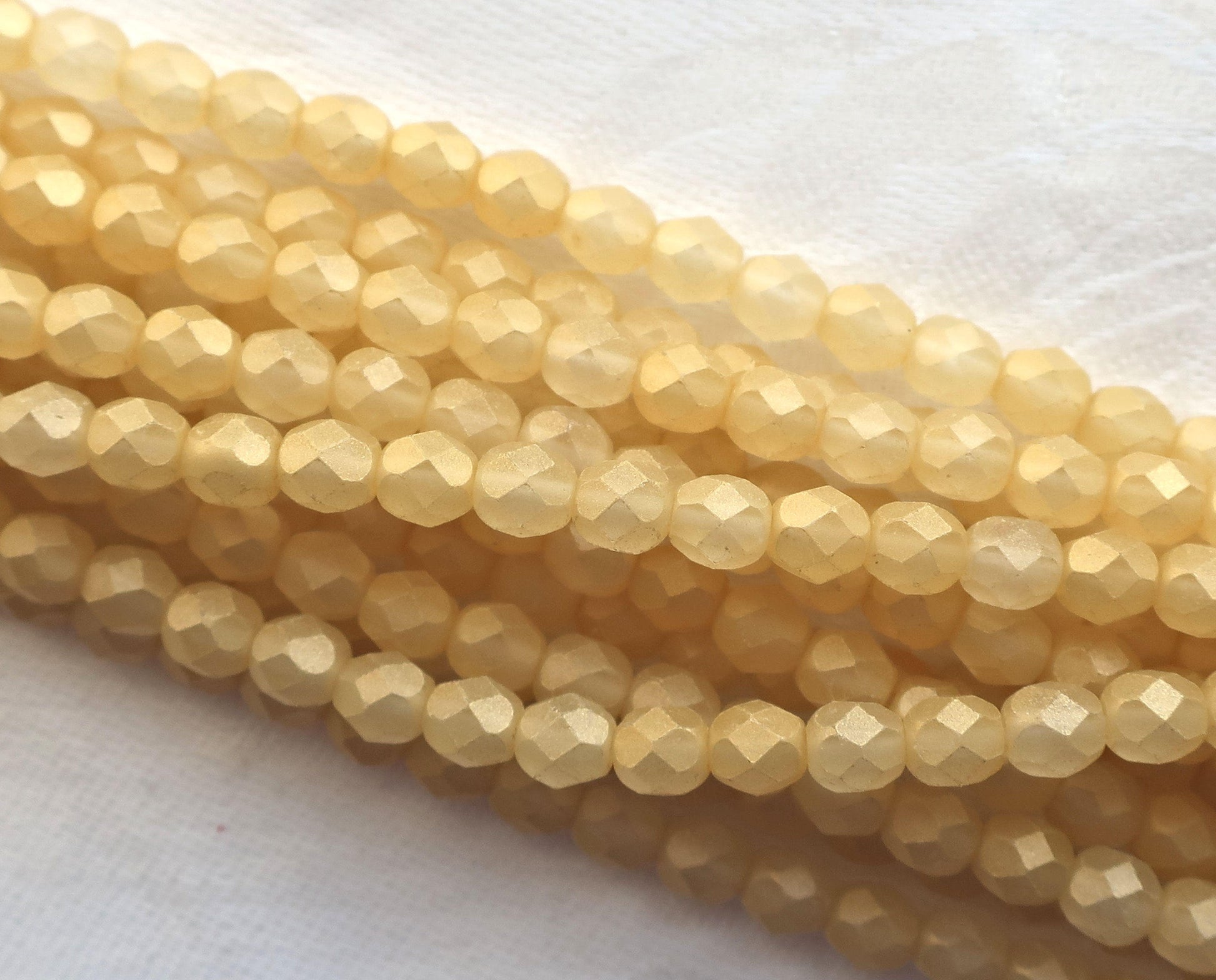 Lot of 25 6mm Sueded Gold Lame, Amber faceted round firepolished glass beads with a frosted gold finish C6425 - Glorious Glass Beads