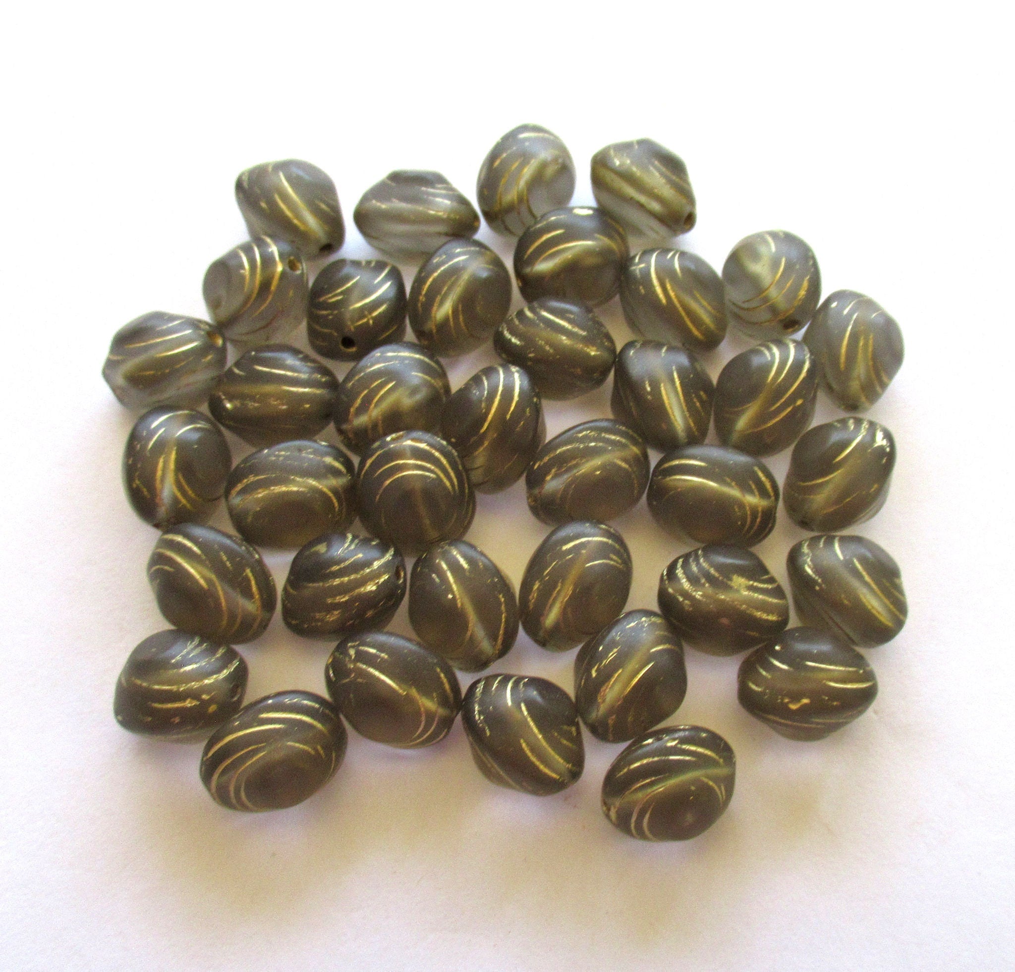 Lot of fifteen oval 10 x 9mm Czech glass snail beads - translucent gray and gold carved glass snail beads C12101