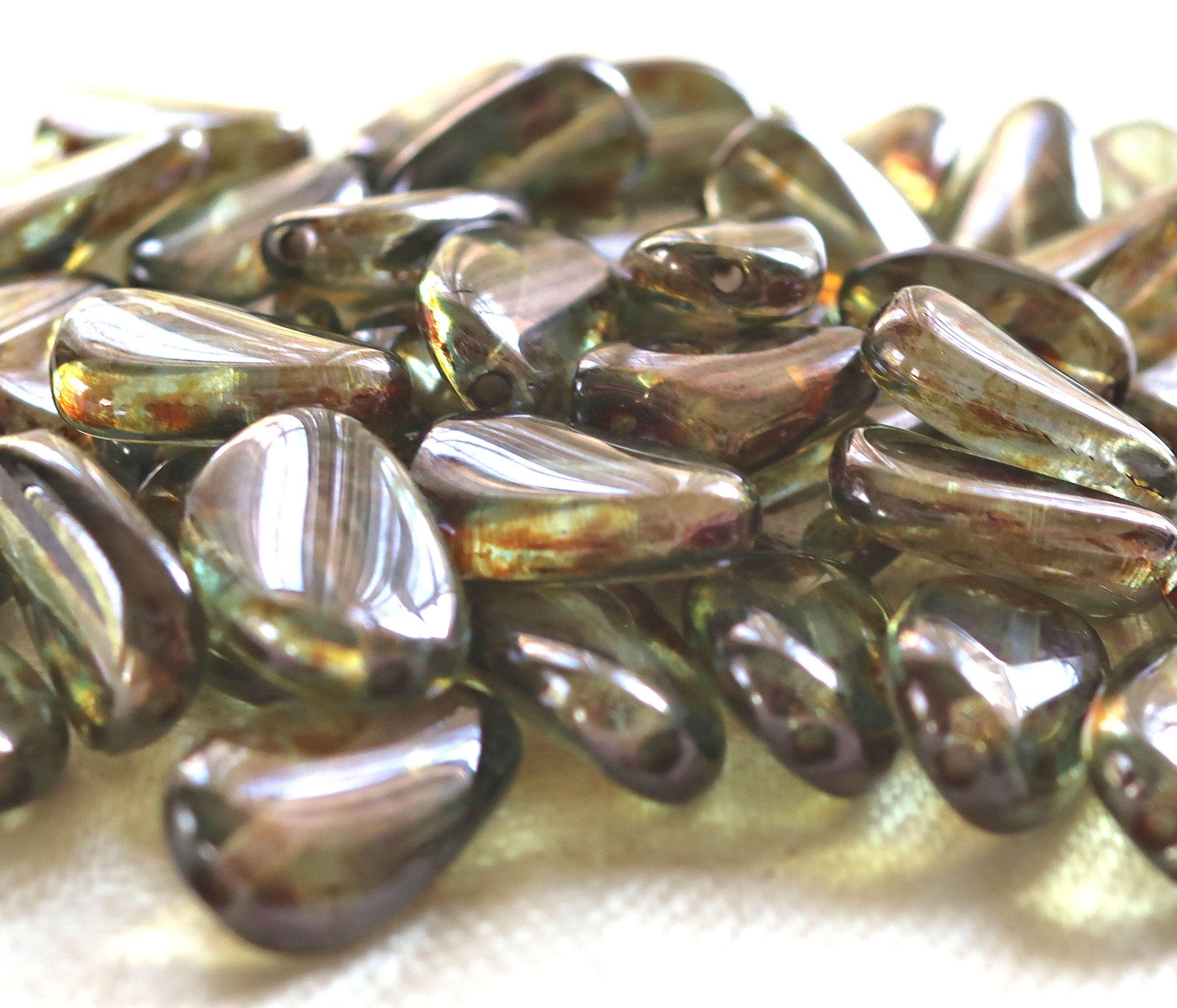 Lot of 25 Lumi Green slightly twisted oval Czech Glass beads, 14mm x 8mm pressed glass beads C36125 - Glorious Glass Beads