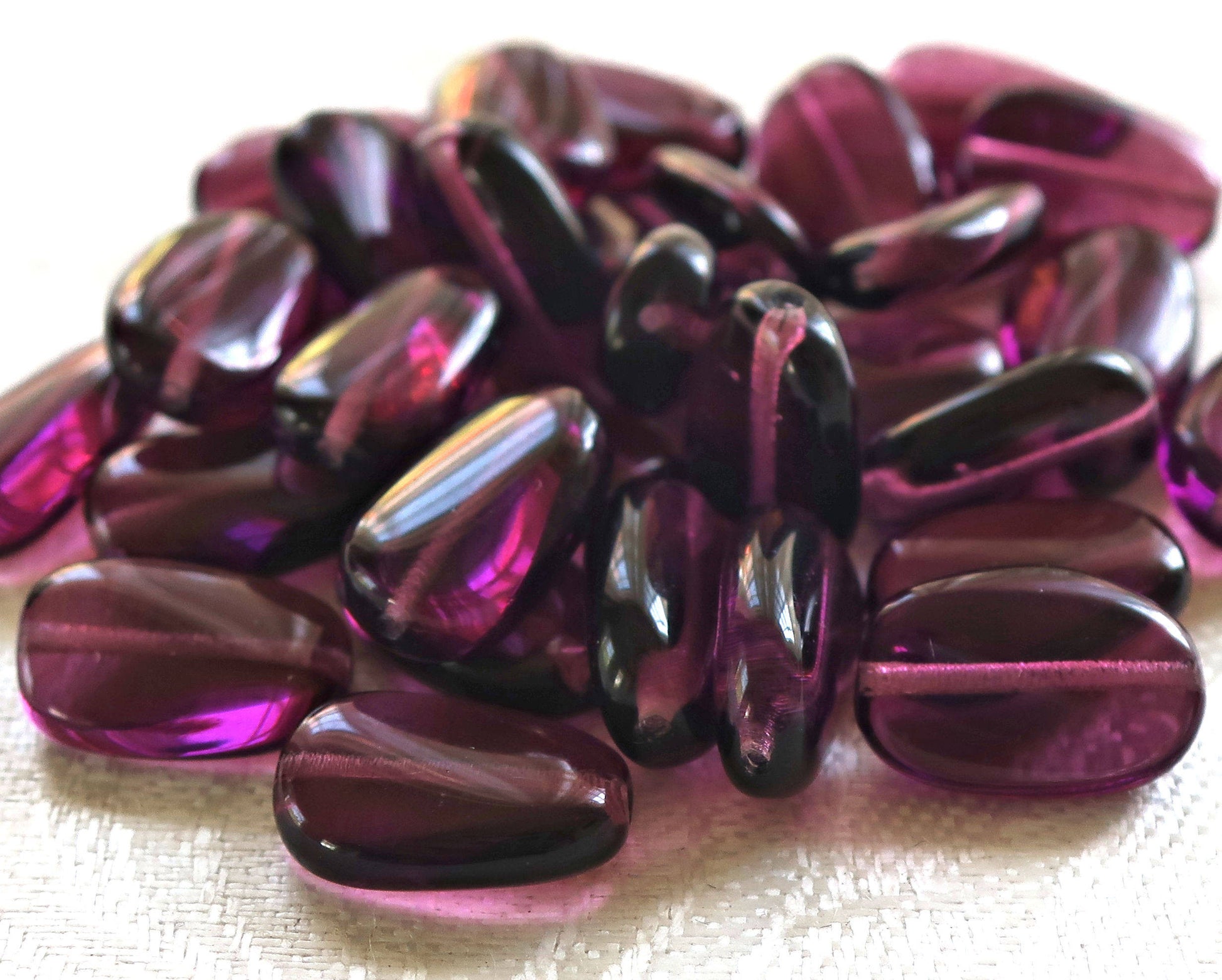 Lot of 25 transparent Amethyst, Purple slightly twisted oval Czech Glass beads, 14mm x 8mm pressed glass beads C2925 - Glorious Glass Beads
