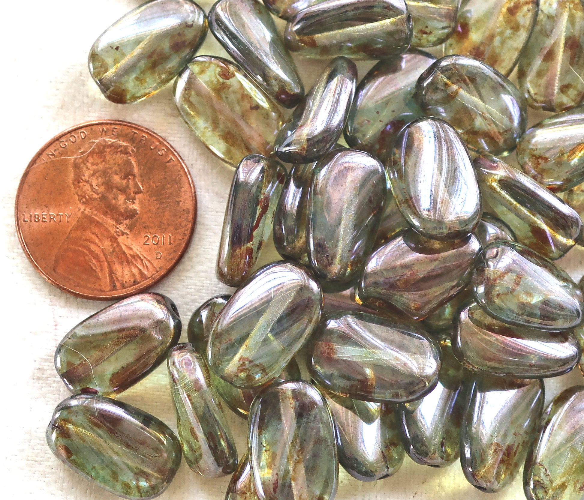 Lot of 25 Lumi Green slightly twisted oval Czech Glass beads, 14mm x 8mm pressed glass beads C36125 - Glorious Glass Beads