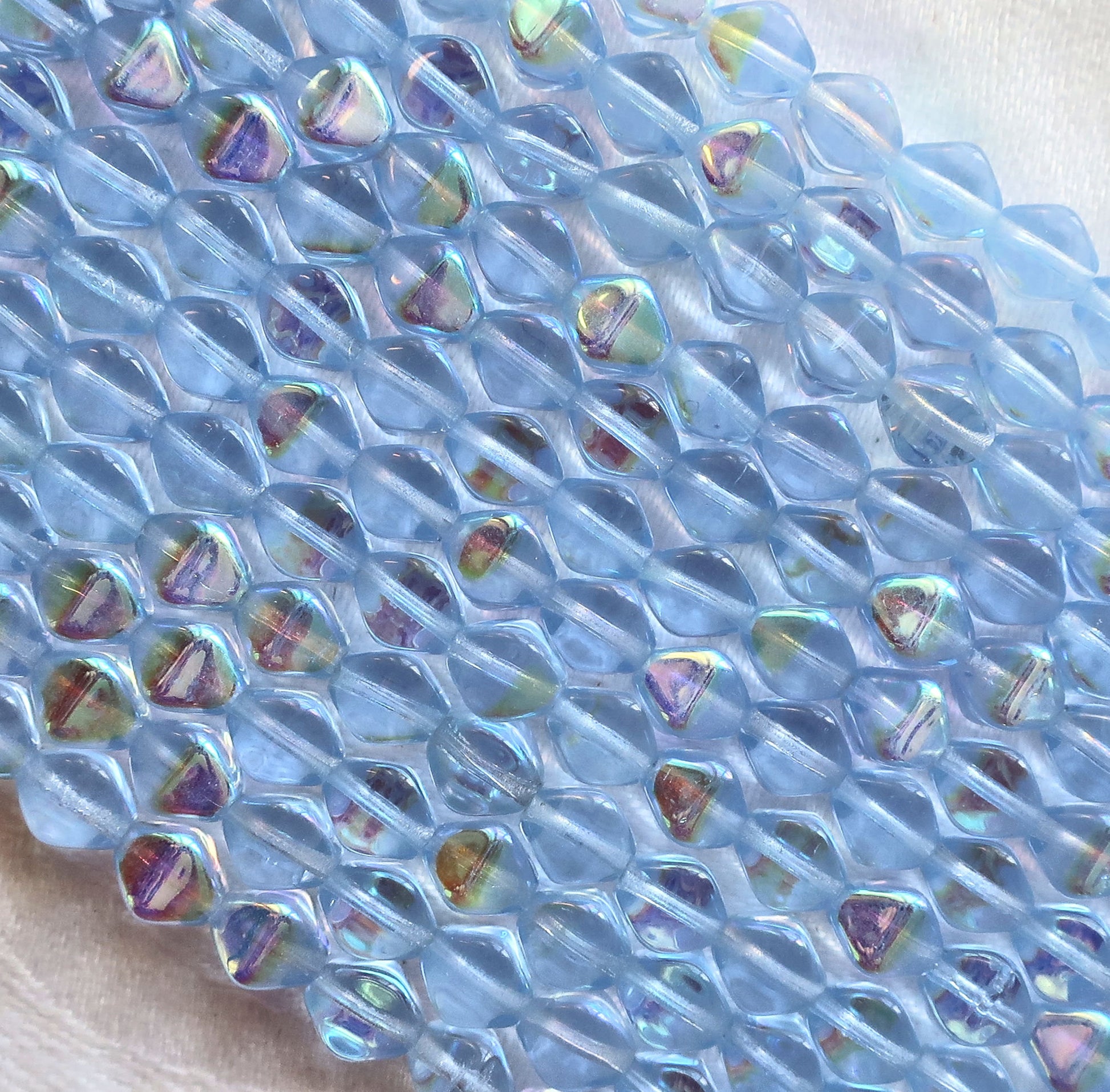 Fifty 6mm Light Sapphire AB bicones, Iridescent blue pressed Czech glass bicone beads C9701 - Glorious Glass Beads