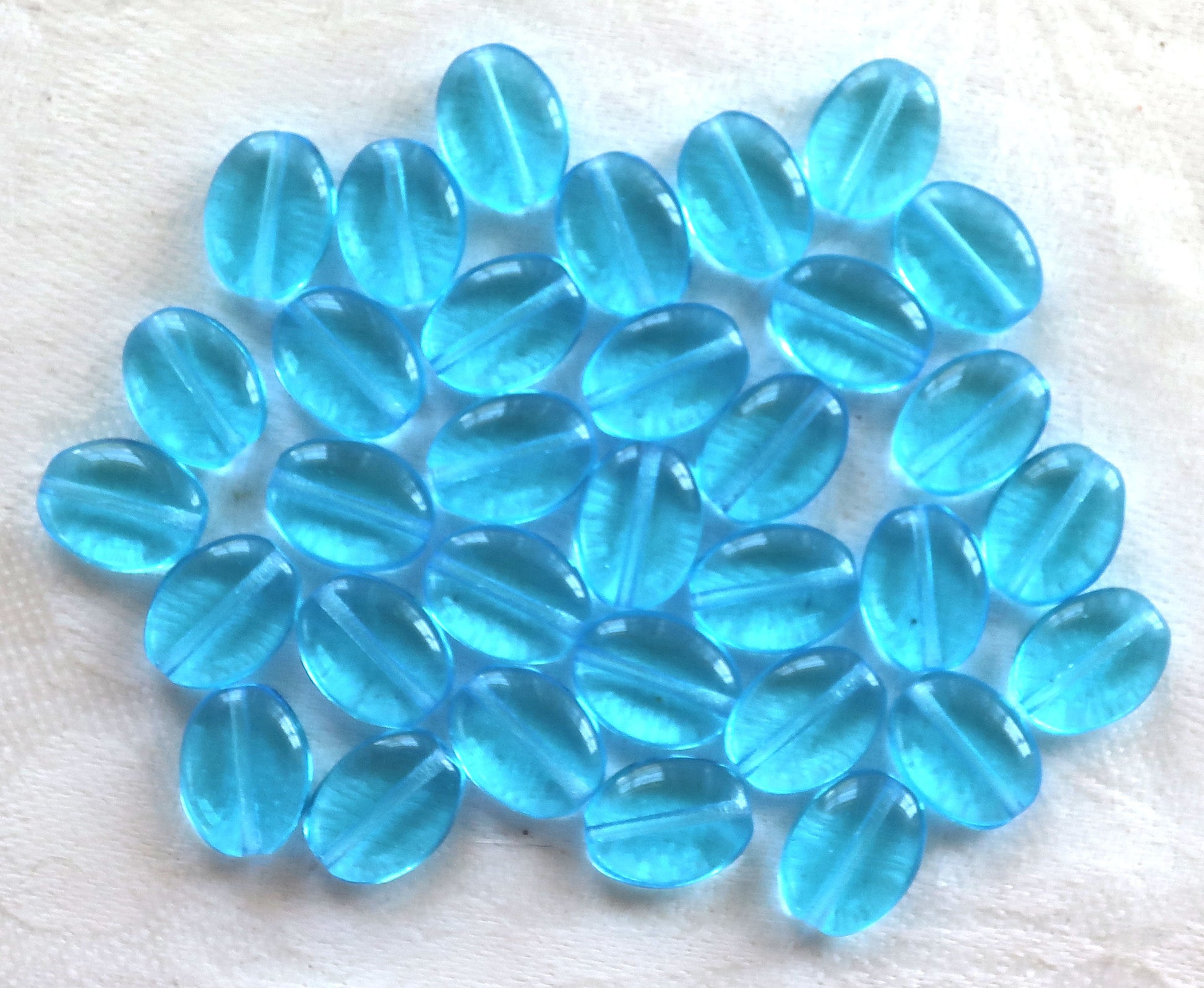 25 transparent Aqua Blue flat oval Czech Glass beads, 12mm x 9mm pressed glass beads C7425 - Glorious Glass Beads