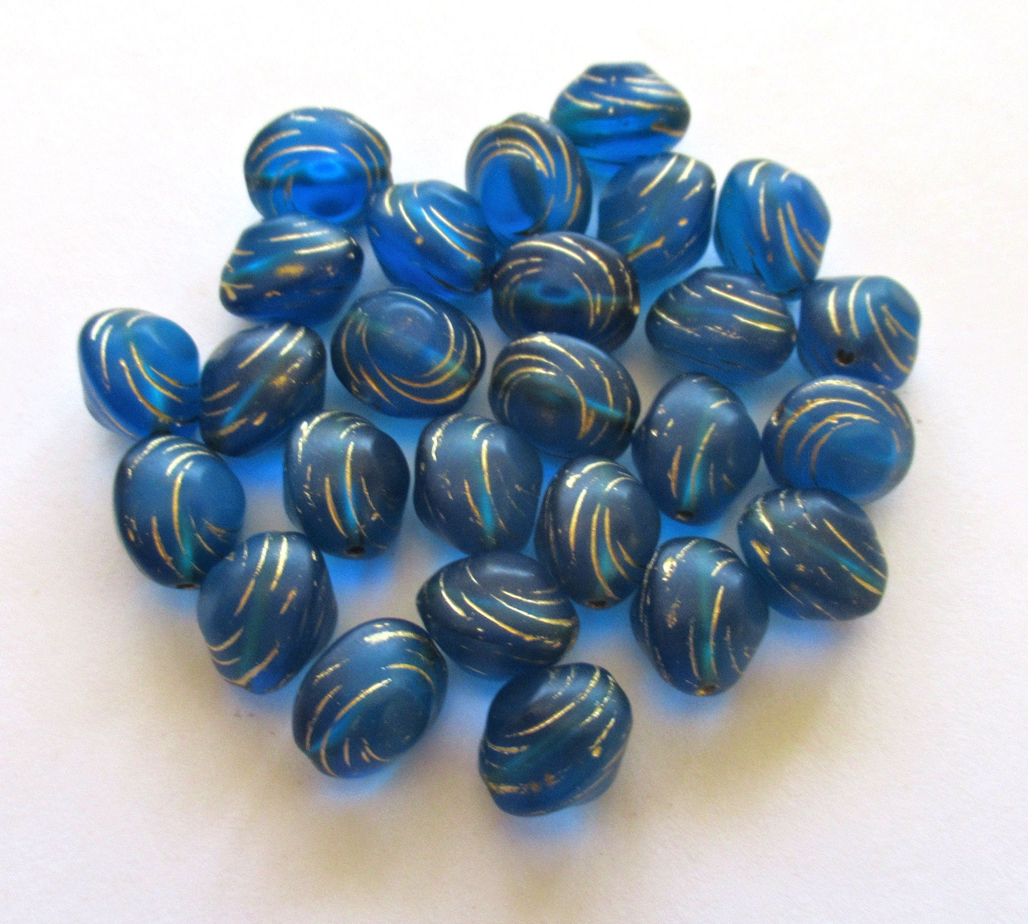 Lot of fifteen oval 10 x 9mm Czech glass snail beads - translucent capri blue and gold carved glass snail beads C12101