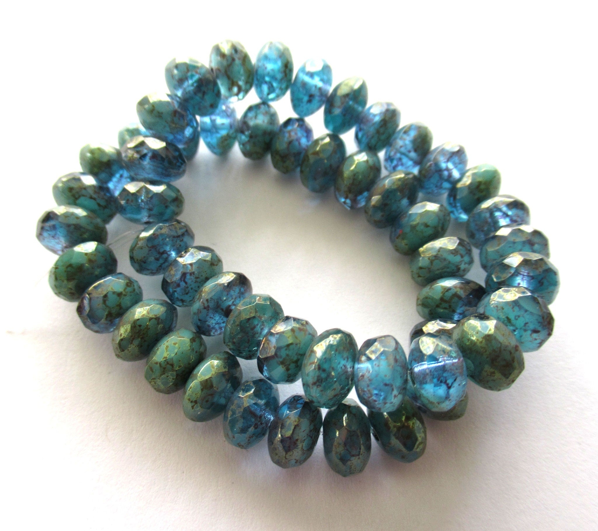 Lot of 25 faceted puffy rondelle or donut Czech glass beads - 5 x 7mm transparent sea blue with a splotchy purple luster finish - C00201