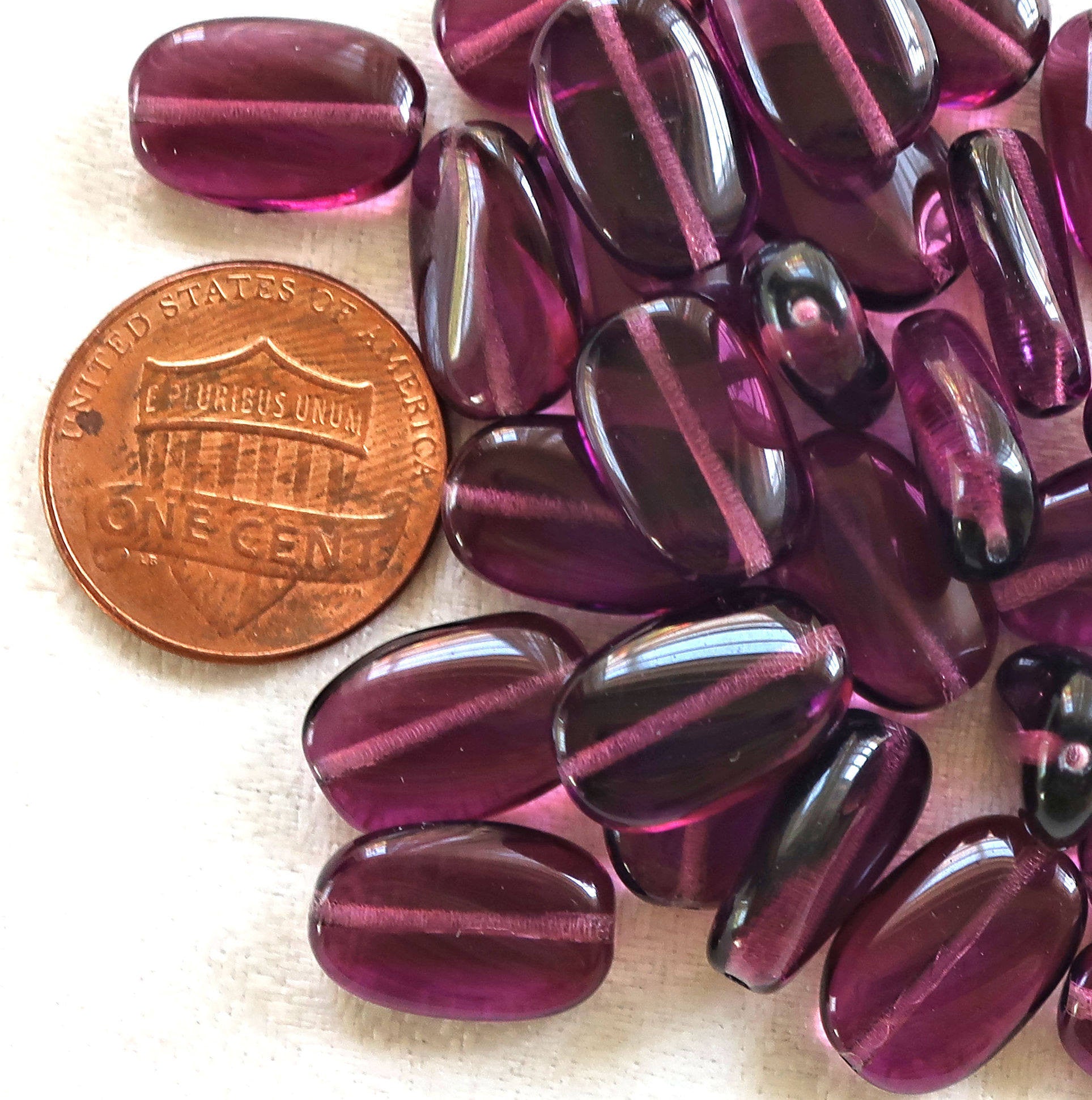 Lot of 25 transparent Amethyst, Purple slightly twisted oval Czech Glass beads, 14mm x 8mm pressed glass beads C2925 - Glorious Glass Beads