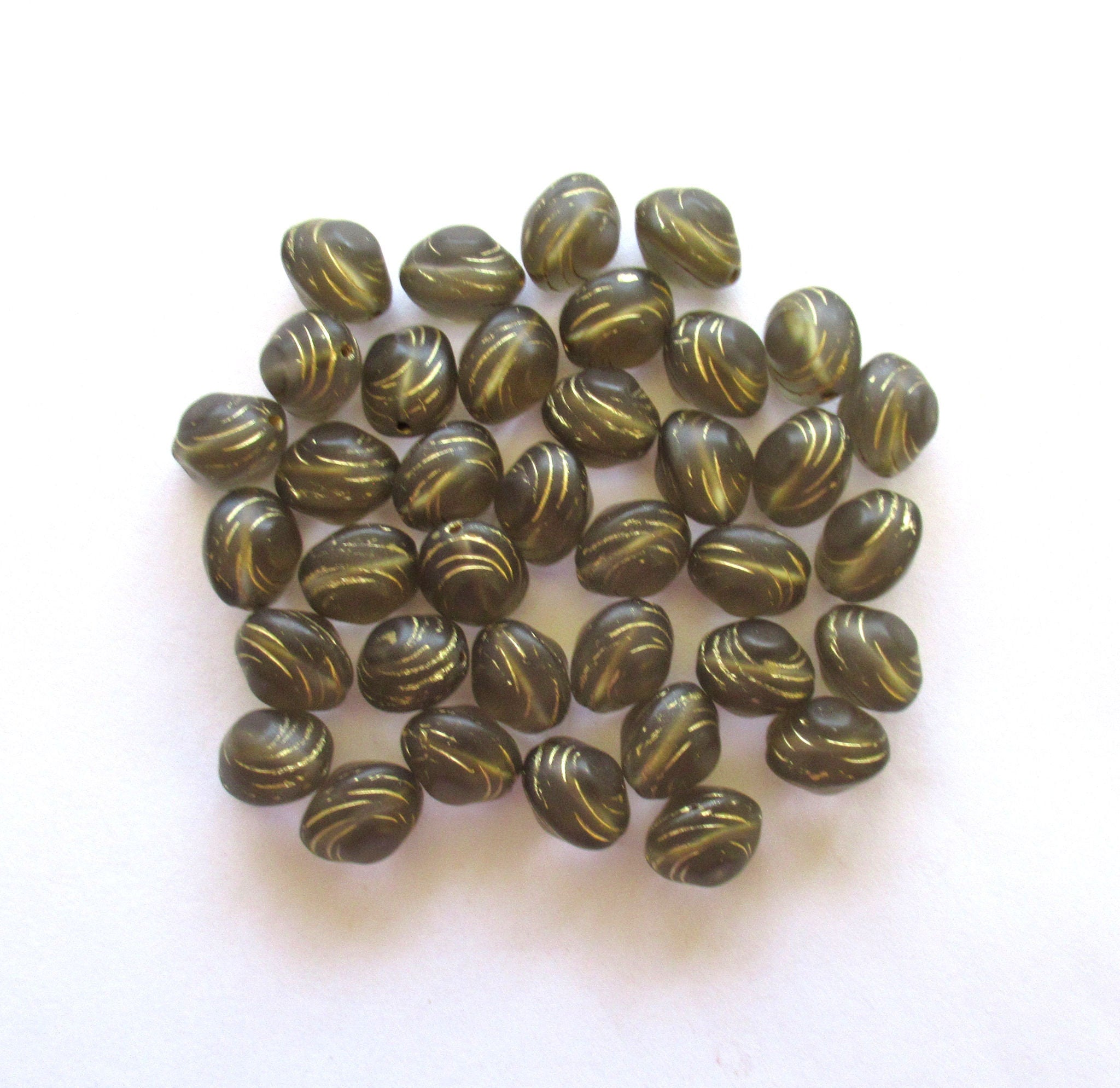 Lot of fifteen oval 10 x 9mm Czech glass snail beads - translucent gray and gold carved glass snail beads C12101