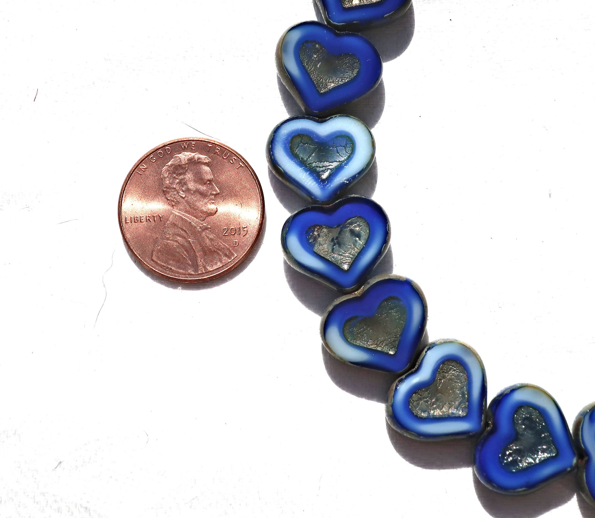 Six Czech glass heart beads; 14 x 12mm table cut, carved, opaque marbled royal blue & white glass hearts with a silver picasso finish C6906 - Glorious Glass Beads