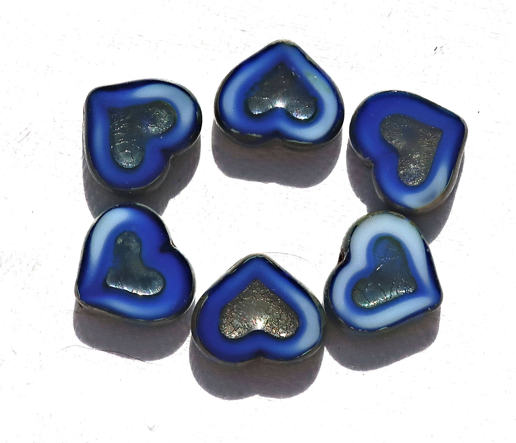 Six Czech glass heart beads; 14 x 12mm table cut, carved, opaque marbled royal blue & white glass hearts with a silver picasso finish C6906 - Glorious Glass Beads