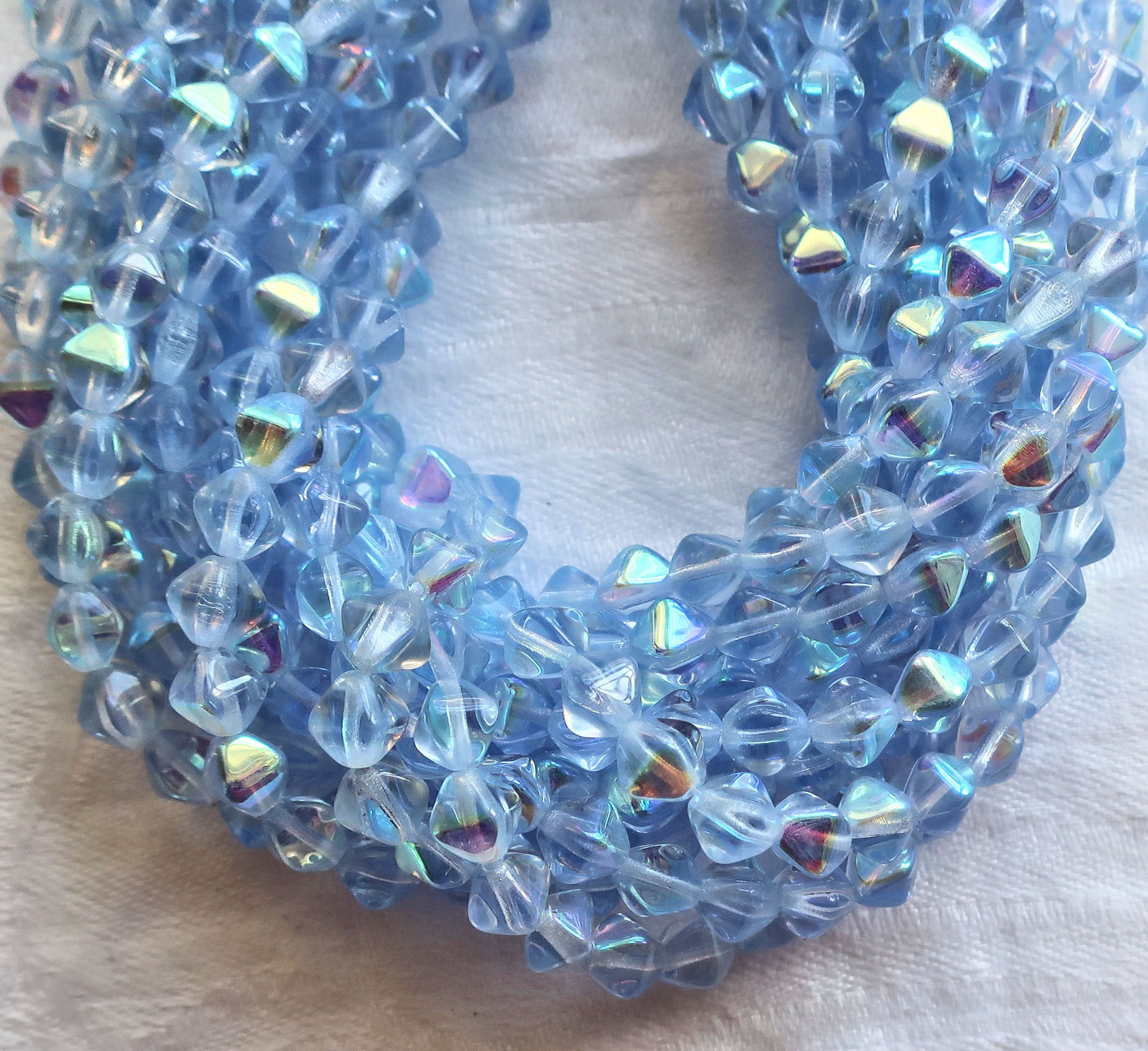Fifty 6mm Light Sapphire AB bicones, Iridescent blue pressed Czech glass bicone beads C9701 - Glorious Glass Beads