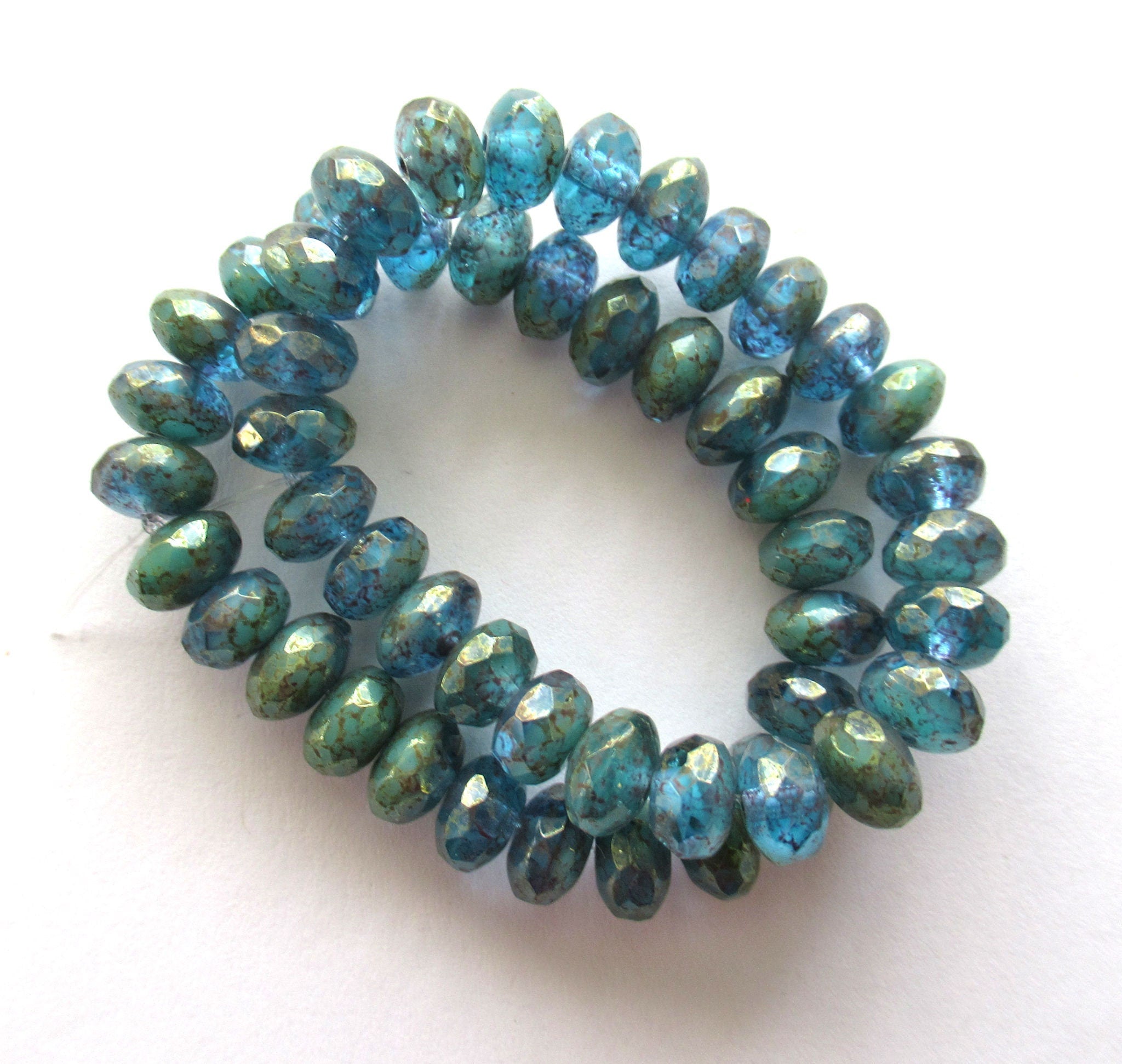 Lot of 25 faceted puffy rondelle or donut Czech glass beads - 5 x 7mm transparent sea blue with a splotchy purple luster finish - C00201