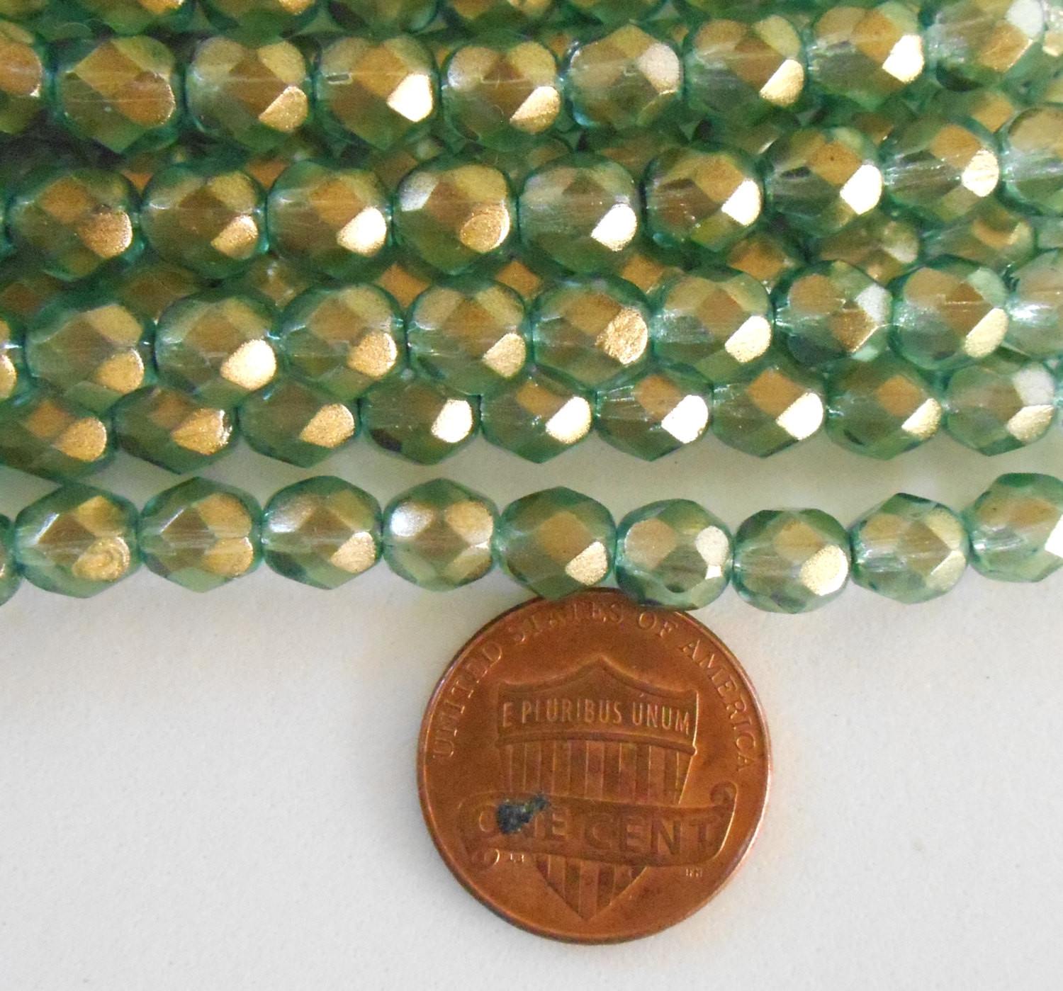 Lot of 25 6mm Halo Heavens green Czech glass, firepolished, faceted round beads with a transparent gold finish, C2925 - Glorious Glass Beads