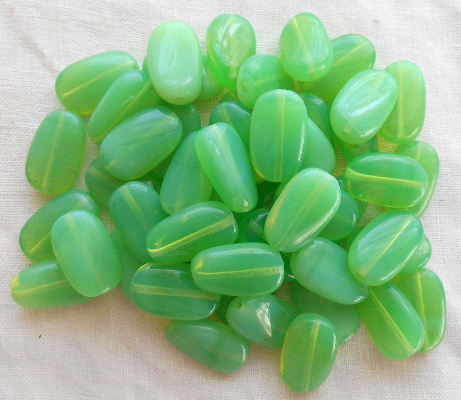 Lot of 25 Jade Green Opal slightly twisted oval Czech pressed Glass beads, 14mm x 8mm, C3625 - Glorious Glass Beads