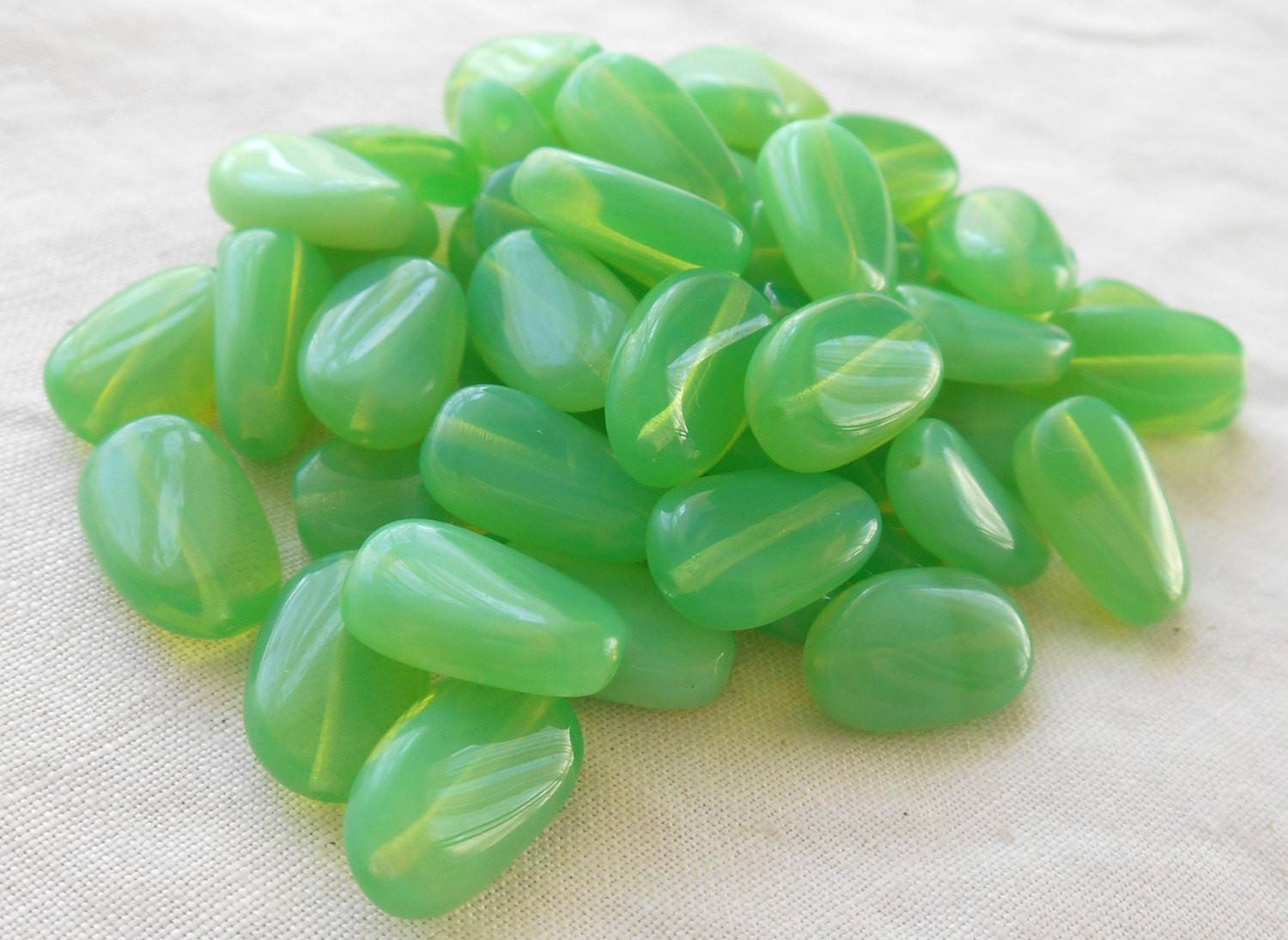 Lot of 25 Jade Green Opal slightly twisted oval Czech pressed Glass beads, 14mm x 8mm, C3625 - Glorious Glass Beads