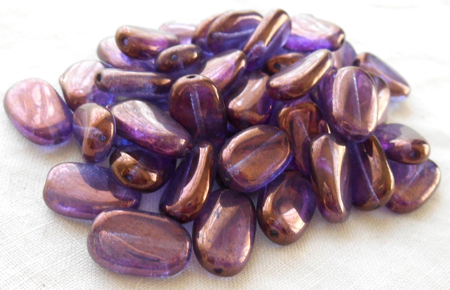 Lot of 25 Lumi Amethyst Iridescent slightly twisted oval Czech pressed Glass beads, 14mm x 8mm, C3325 - Glorious Glass Beads