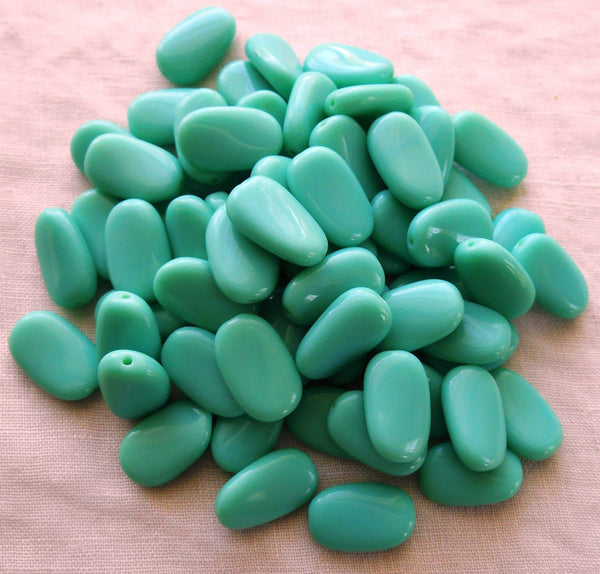 Lot of 15 Opaque Turquoise slightly twisted oval Czech pressed Glass beads, 14mm x 8mm, C00161