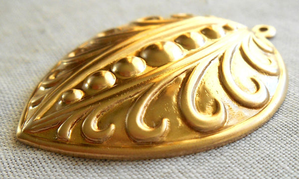 One Raw Brass Stamping, Victorian, Art Nouveau, pea pod like pendant, charm, drop, earring, 39mm x 29mm, made in the USA, C2201 - Glorious Glass Beads